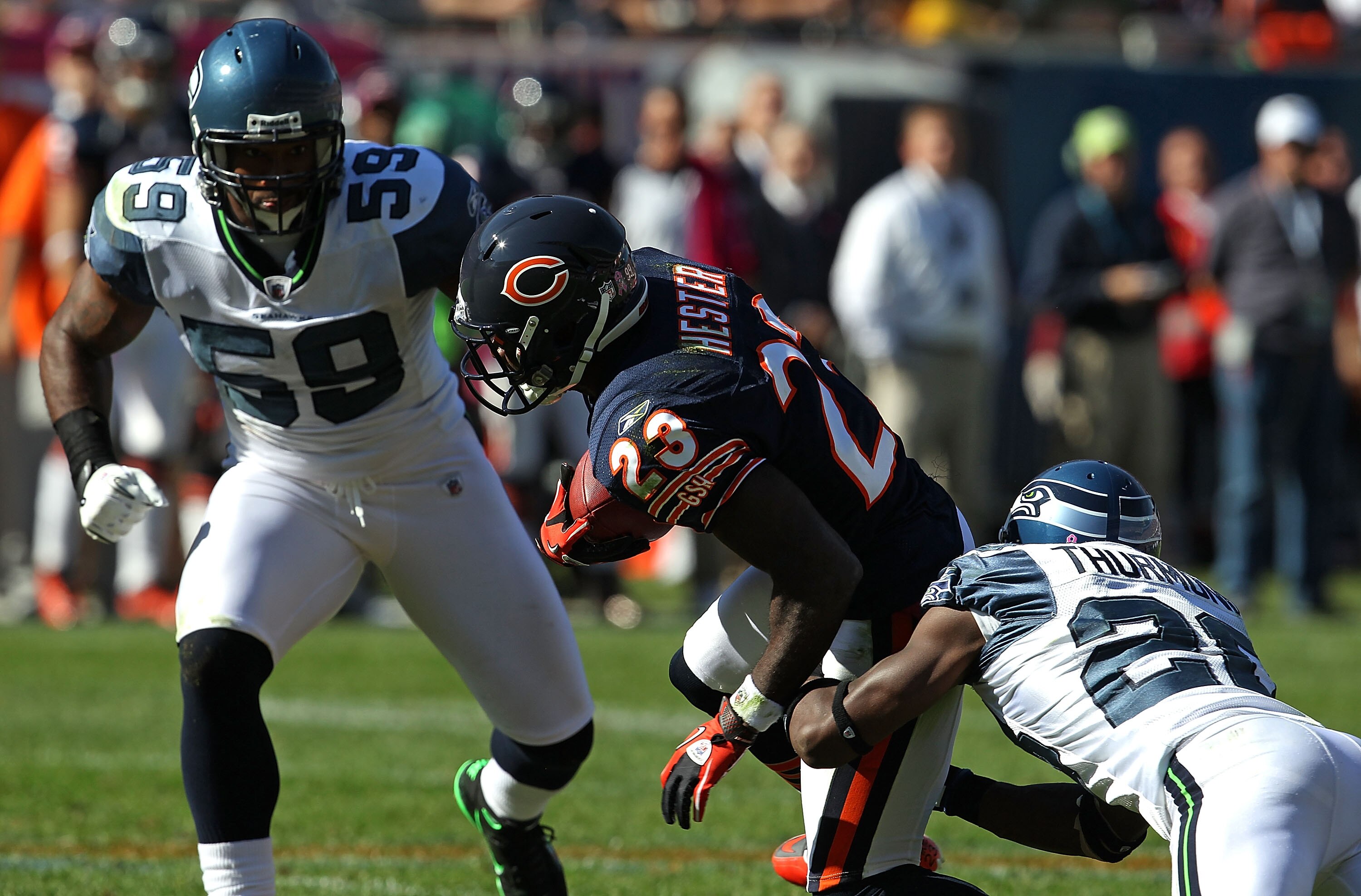 CHICAGO - OCTOBER 17: Devin Hester #23 of the Chicago Bears is tackled by Walter Thurmond #28 and Aaron Curry #59 of the Seattle Seahawks at Soldier Field on October 17, 2010 in Chicago, Illinois. The Seahawks defeated the Bears 23-20.  (Photo by Jonathan