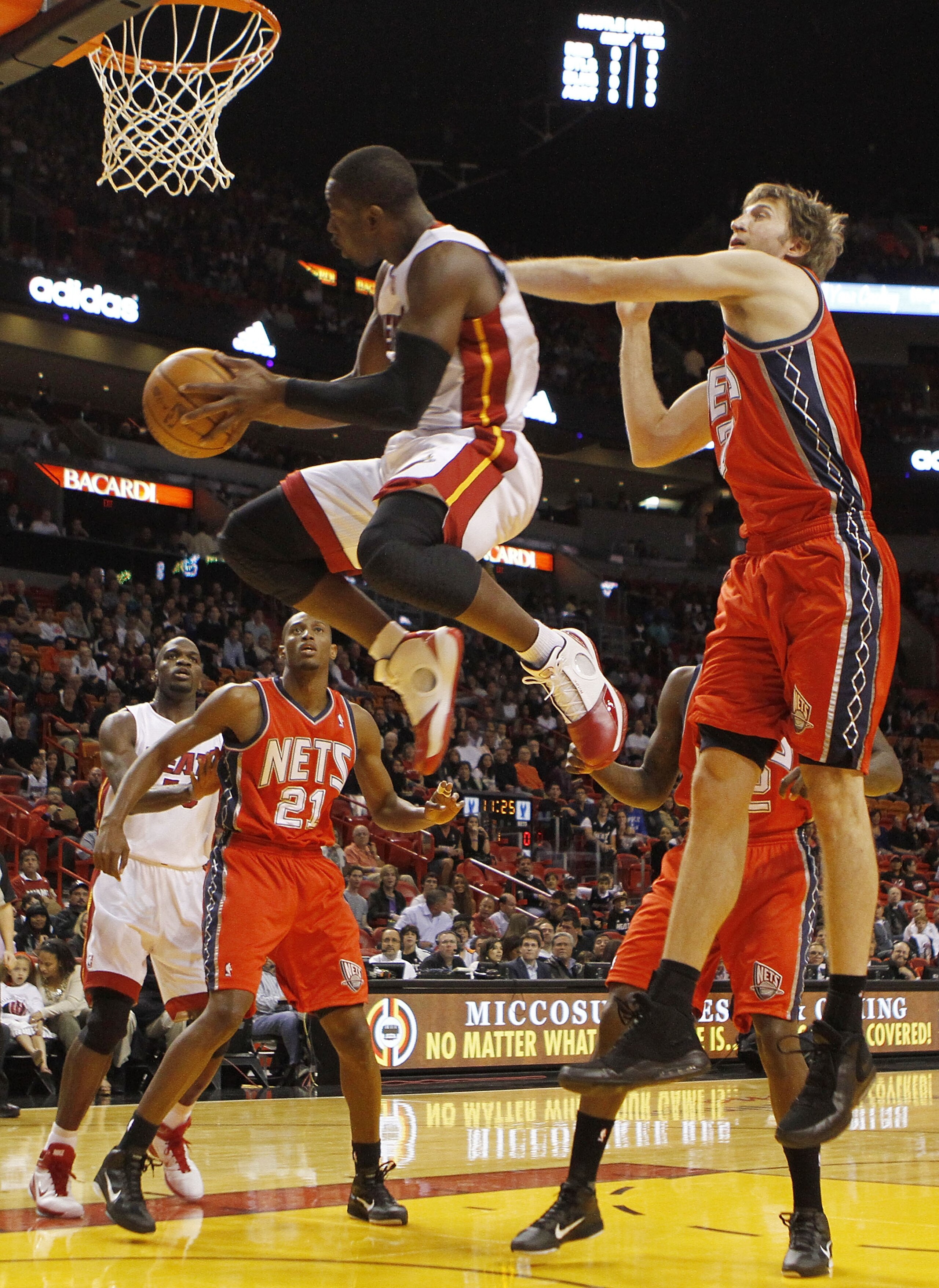 MIAMI - NOVEMBER 06:  Guard Dwyane Wade #3 of the Miami Heat dunks against forward Troy Murphy #7 of the New Jersey Nets  at American Airlines Arena on November 6, 2010 in Miami, Florida. NOTE TO USER: User expressly acknowledges and agrees that, by downl