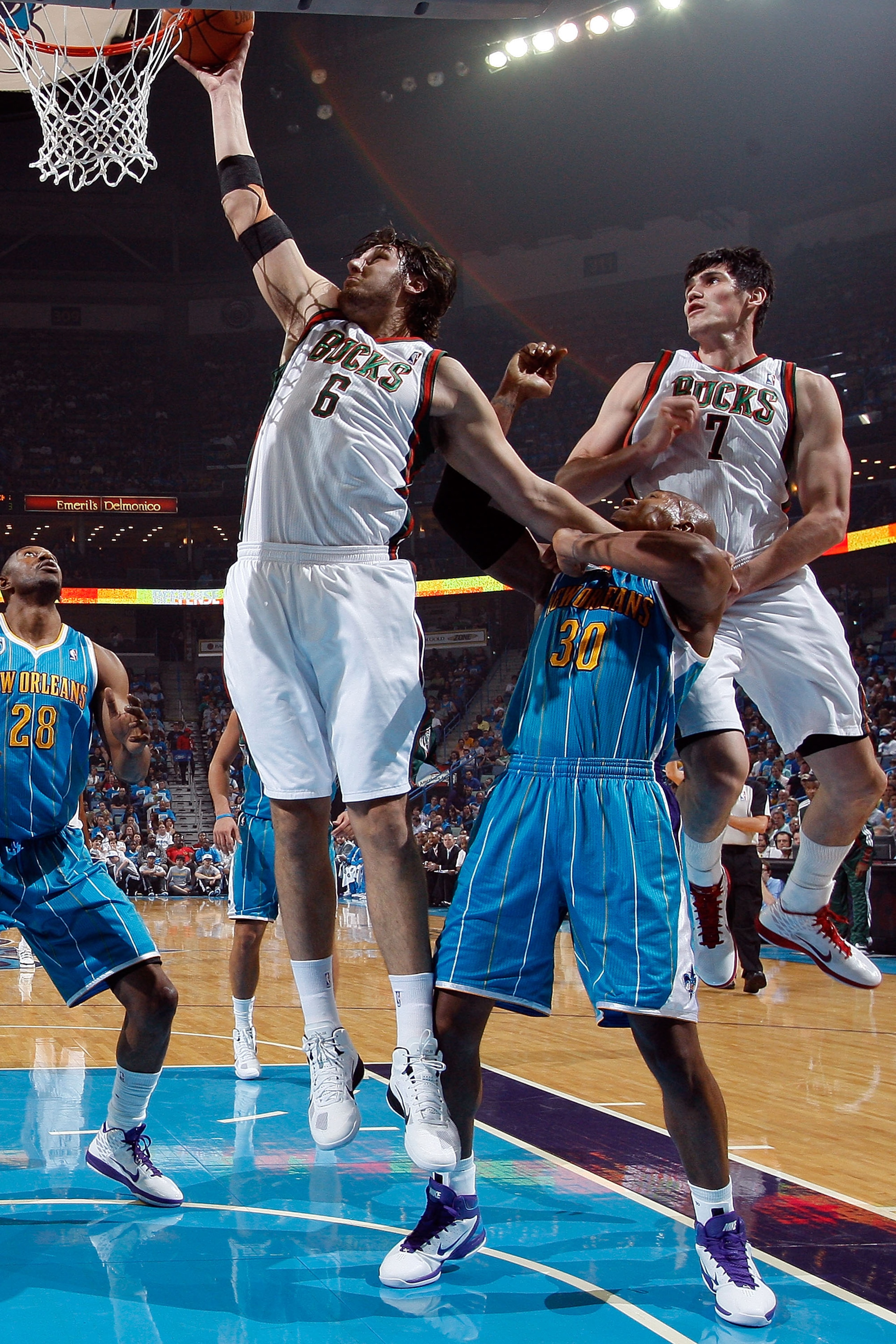 NEW ORLEANS - OCTOBER 27: Andrew Bogut #6 of the Milwaukee Bucks shoots the ball over Emeka Okafor #50 of the New Orleans Hornets at the New Orleans Arena on October 27, 2010 in New Orleans, Louisiana. The Hornets defeated the Bucks 95-91. NOTE TO US NEW ORLEANS - OCTOBER 27: Andrew Bogut #6 of the Milwaukee Bucks shoots the ball over Emeka Okafor #50 of the New Orleans Hornets at the New Orleans Arena on October 27, 2010 in New Orleans, Louisiana. The Hornets defeated the Bucks 95-91. NOTE TO US