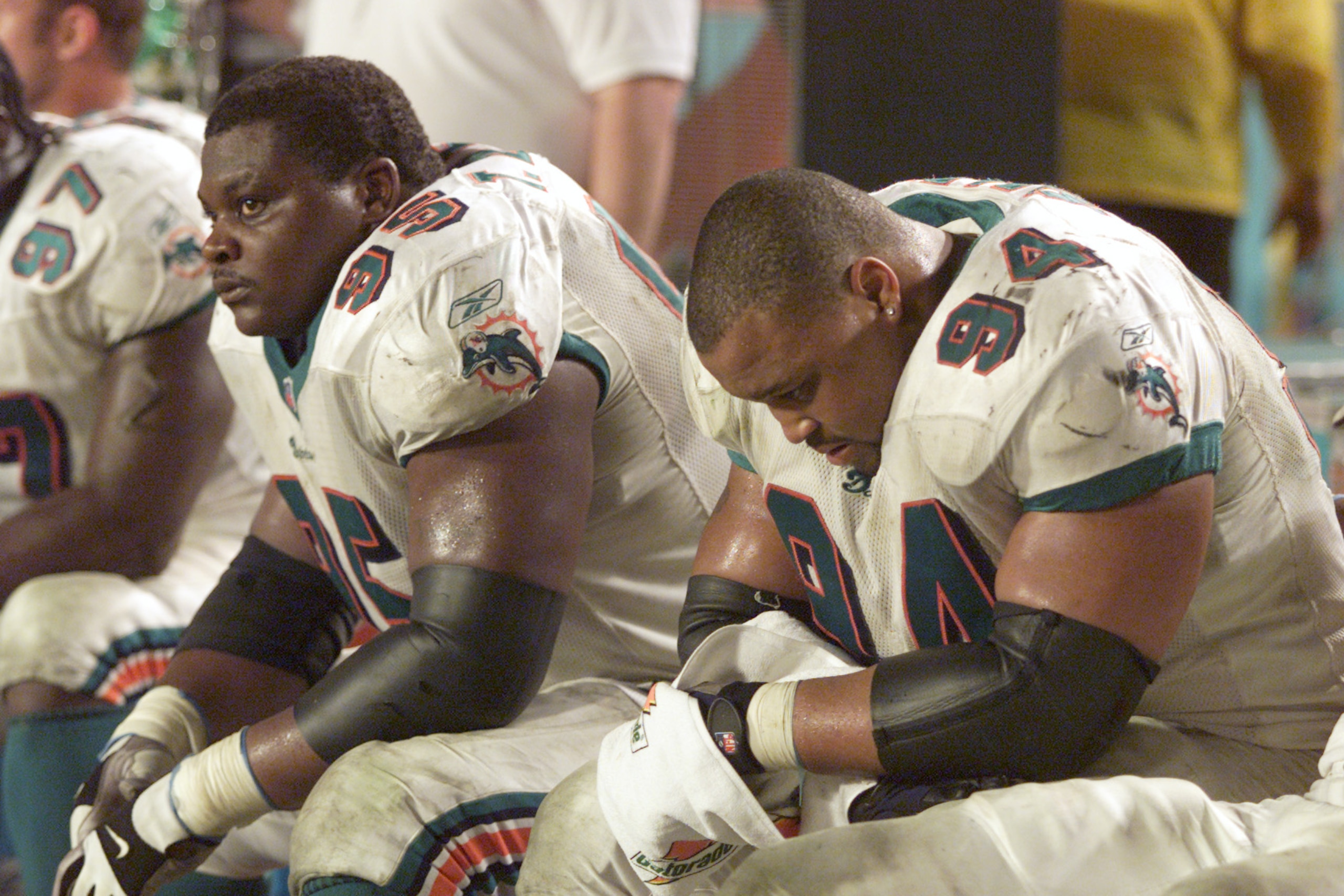 13 Jan 2001:  Tim Bowens #95 and teammate Jermaine Haley #94 of the Miami Dolphins look dejected as they watch their team loose to the Baltimore Ravens during the AFC Playoff game at Pro Player Stadium in Miami, Florida. The Ravens won 20-3. DIGITAL IMAGE