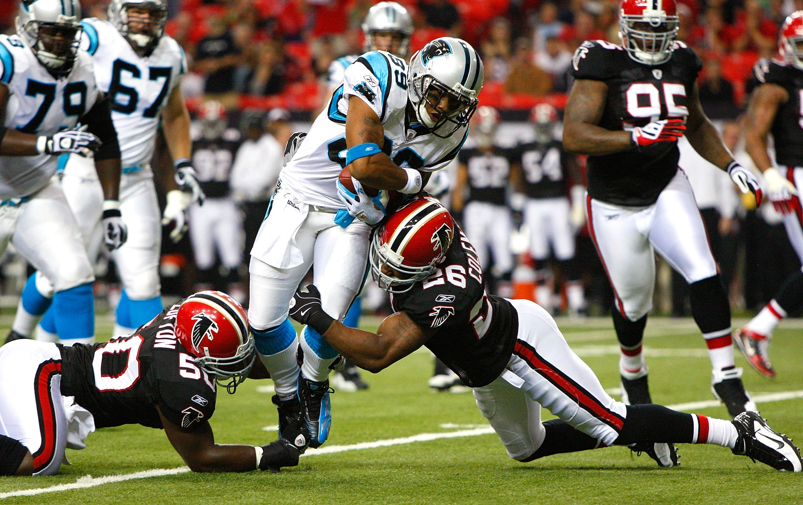 ATLANTA - SEPTEMBER 20: Curtis Lofton #50 and Chris Houston #23 of the Atlanta Falcons tackle Steve Smith #89 of the Carolina Panthers at Georgia Dome on September 20, 2009 in Atlanta, Georgia. (Photo by Kevin C. Cox/Getty Images) ATLANTA - SEPTEMBER 20: Curtis Lofton #50 and Chris Houston #23 of the Atlanta Falcons tackle Steve Smith #89 of the Carolina Panthers at Georgia Dome on September 20, 2009 in Atlanta, Georgia. (Photo by Kevin C. Cox/Getty Images)