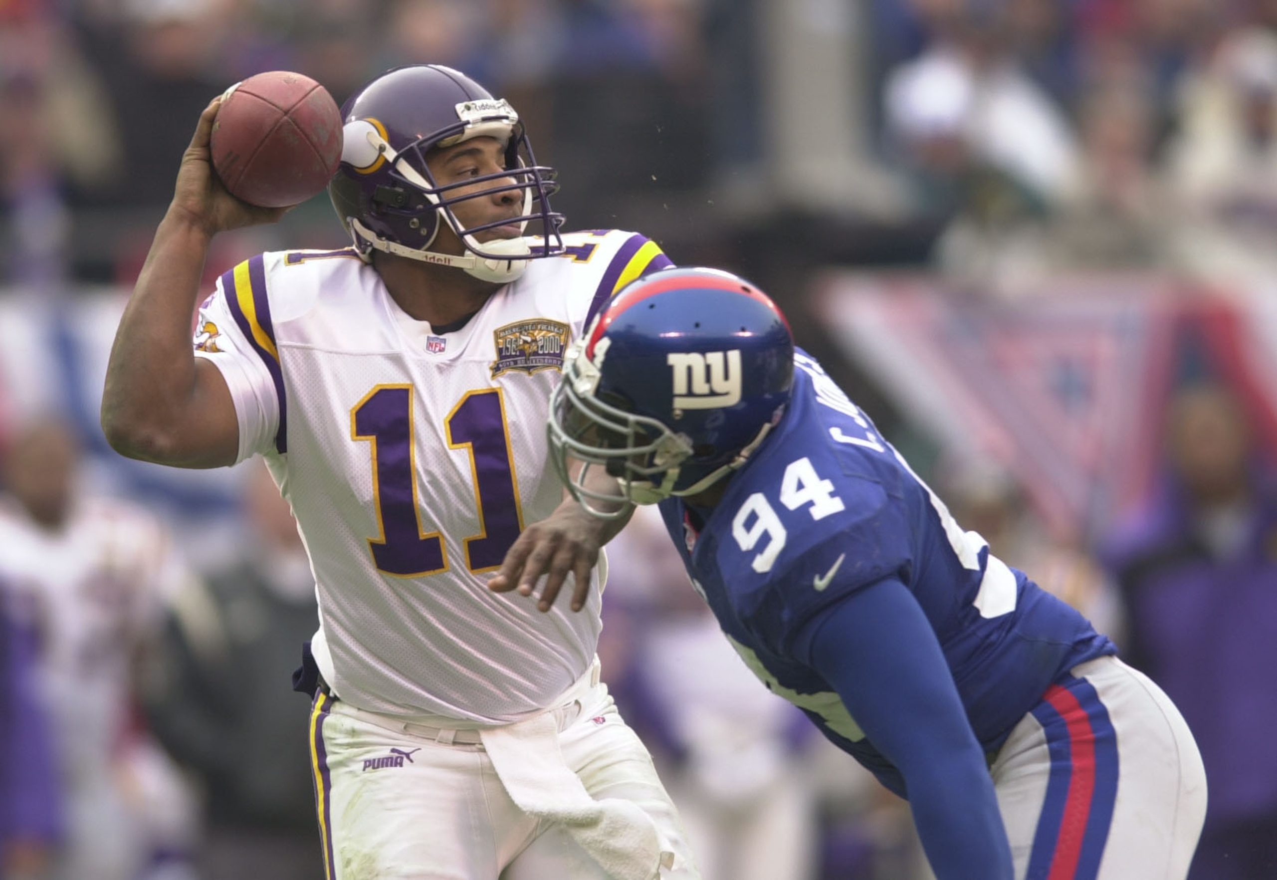 14 Jan 2001:   Daunte Culpepper #11 of the Minnesota Vikings tries to escape the grasp of Cedric Jones #94 of the New York Giants during the third period of the NFC Championship game at Giants Stadium in East Rutherford, New Jersey. The Giants won 41-0. <