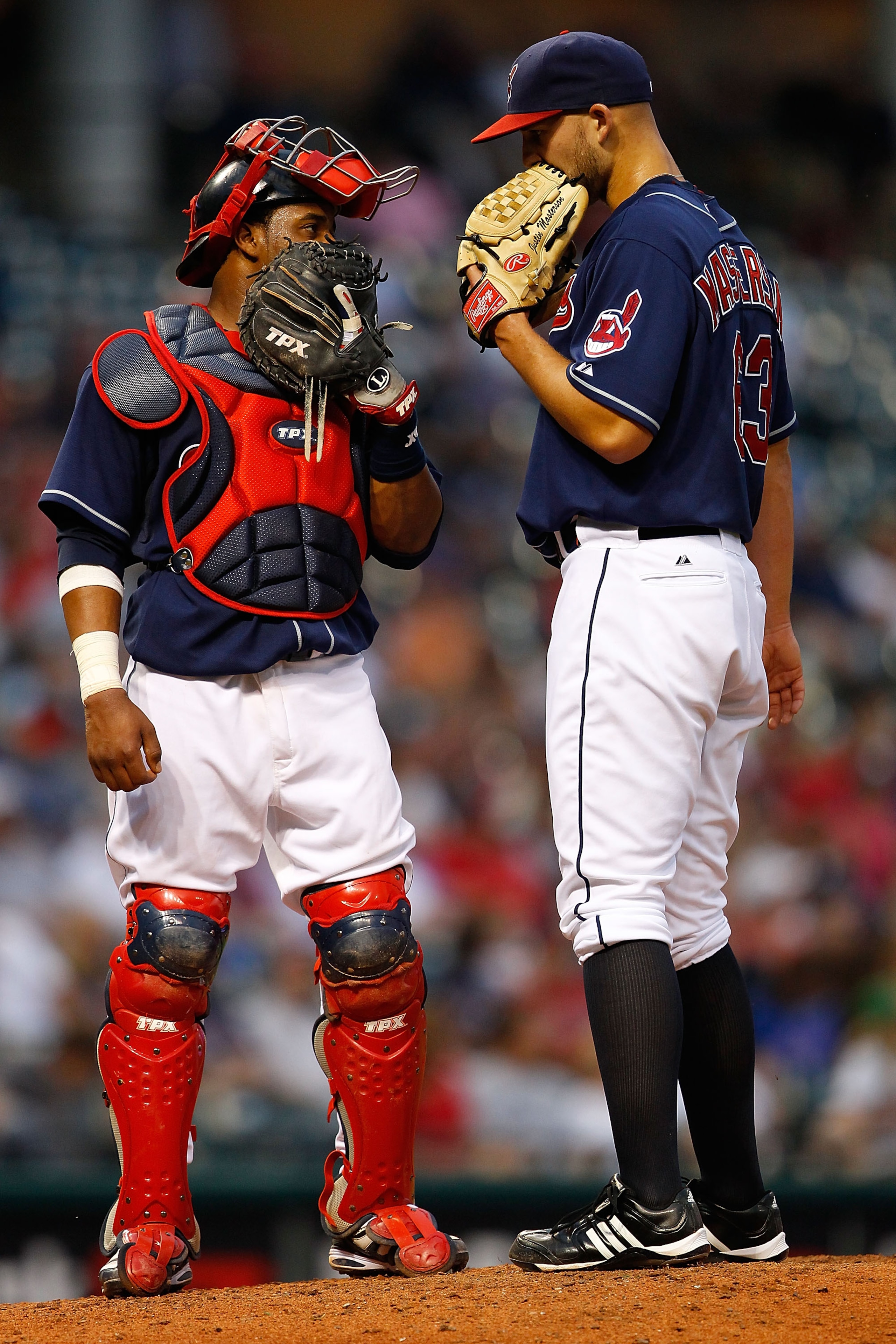 CLEVELAND - JUNE 15:  Carlos Santana #41 of the Cleveland Indians talks with teammate Justin Masterson #63 at the mound during the game against the New York Mets on June 15, 2010 at Progressive Field in Cleveland, Ohio.  (Photo by Jared Wickerham/Getty Im