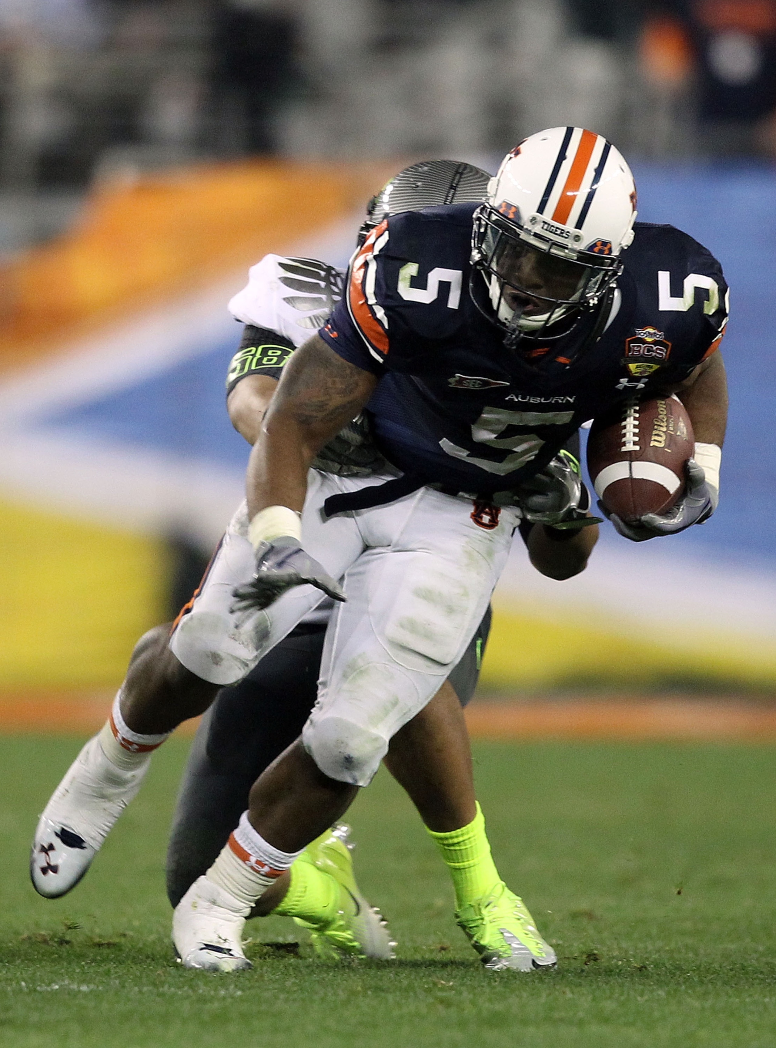 GLENDALE, AZ - JANUARY 10: Michael Dyer #5 of the Auburn Tigers is tackled by Kenny Rowe #58 of the Oregon Ducks during the Tostitos BCS National Championship Game at University of Phoenix Stadium on January 10, 2011 in Glendale, Arizona. (Photo by Chri GLENDALE, AZ - JANUARY 10: Michael Dyer #5 of the Auburn Tigers is tackled by Kenny Rowe #58 of the Oregon Ducks during the Tostitos BCS National Championship Game at University of Phoenix Stadium on January 10, 2011 in Glendale, Arizona. (Photo by Chri