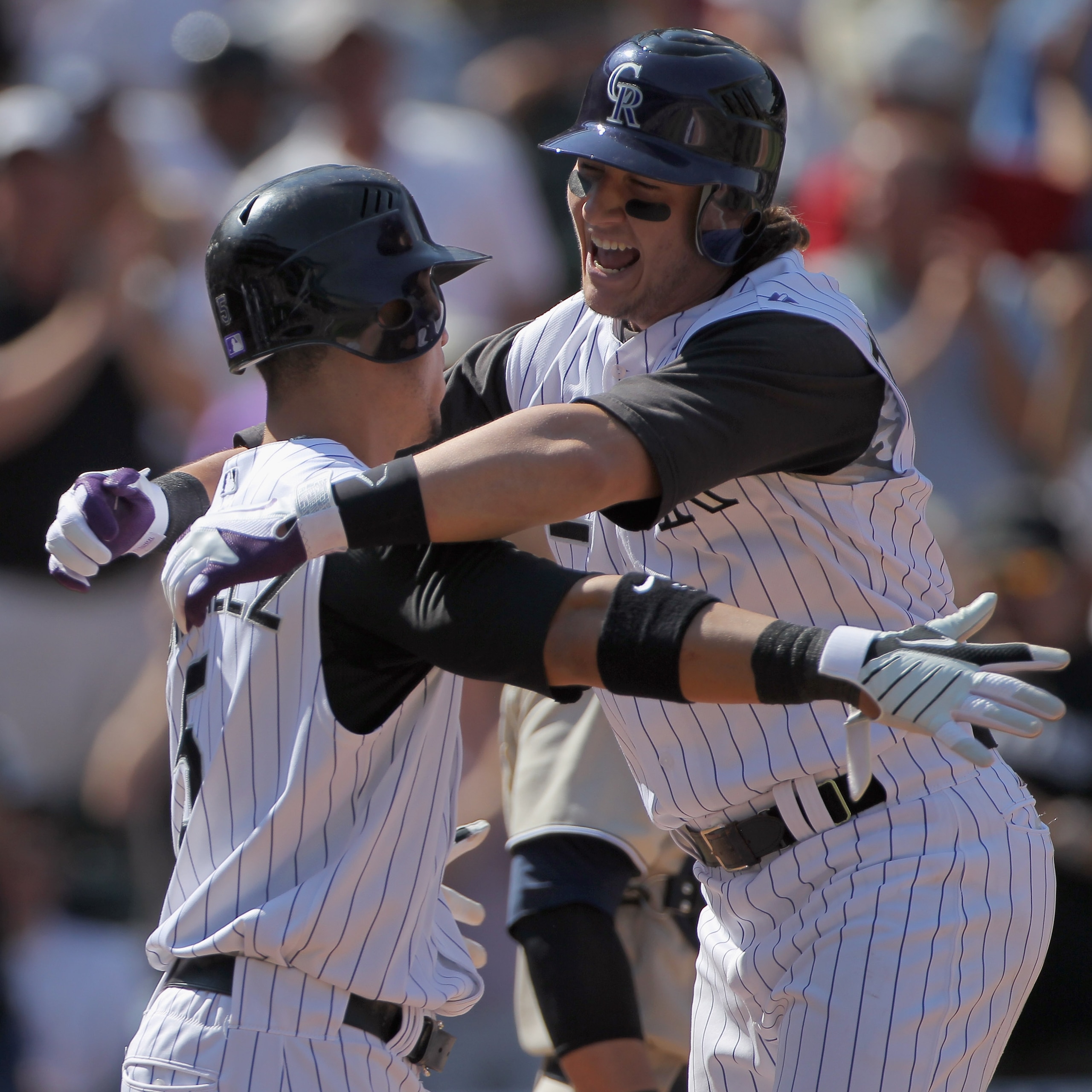 DENVER - SEPTEMBER 15:  Troy Tulowitzki #2 of the Colorado Rockies celebrates his three run home run with Carlos Gonzalez #5 who scored on the play as the Rockies took a 5-1 lead over the San Diego Padres in the third inning at Coors Field on September 15