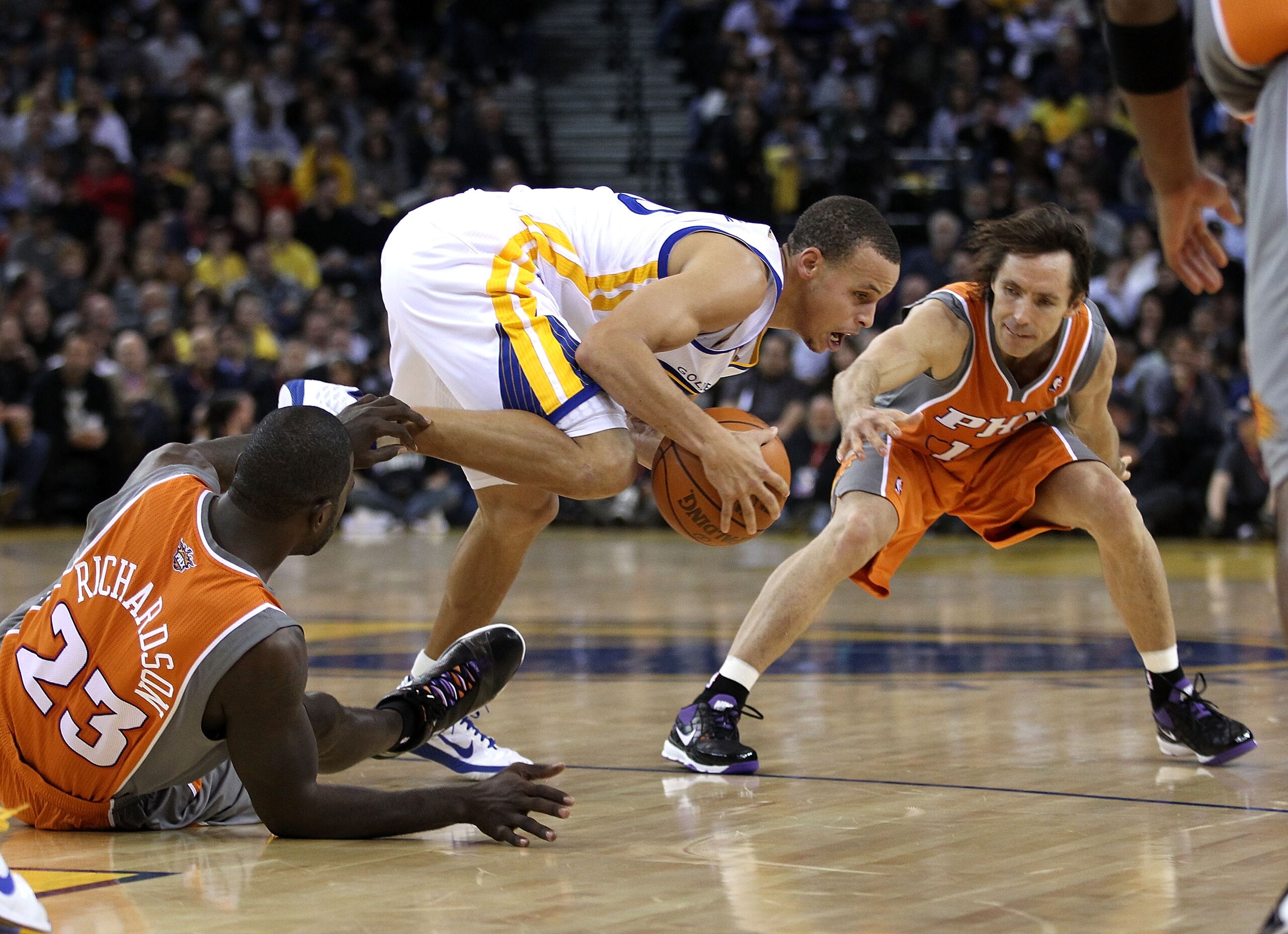 OAKLAND, CA - DECEMBER 02:  Stephen Curry #30 of the Golden State Warriors steals the ball from Jason Richardson #23 and Steve Nash #13 of the Phoenix Suns at Oracle Arena on December 2, 2010 in Oakland, California. NOTE TO USER: User expressly acknowledg