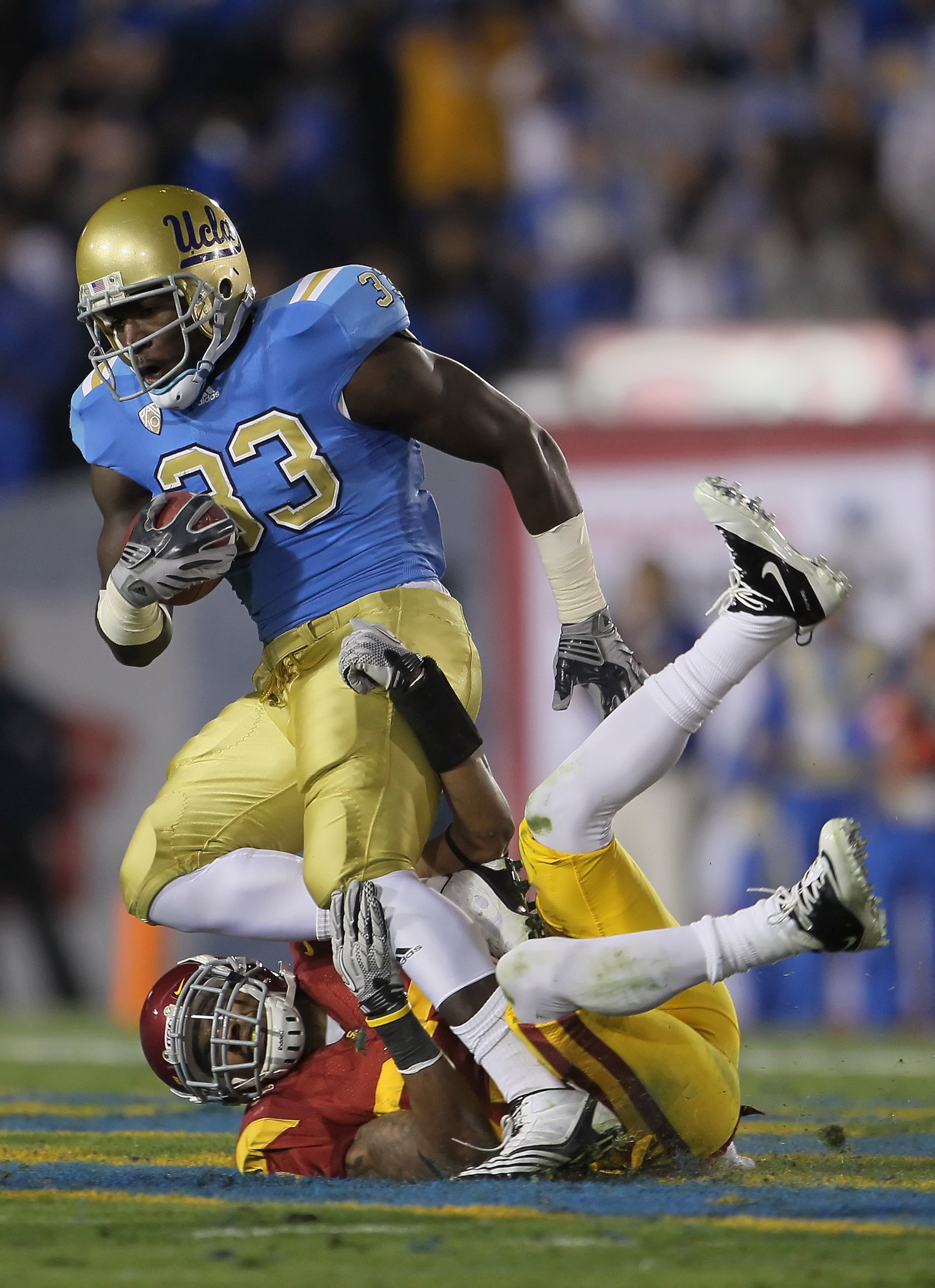 PASADENA, CA - DECEMBER 04:  Running back Derrick Coleman #33 of the UCLA Bruins is brought down by Marshall Jones #27 of the USC Trojans during the first half at the Rose Bowl on December 4, 2010 in Pasadena, California.  (Photo by Jeff Gross/Getty Image