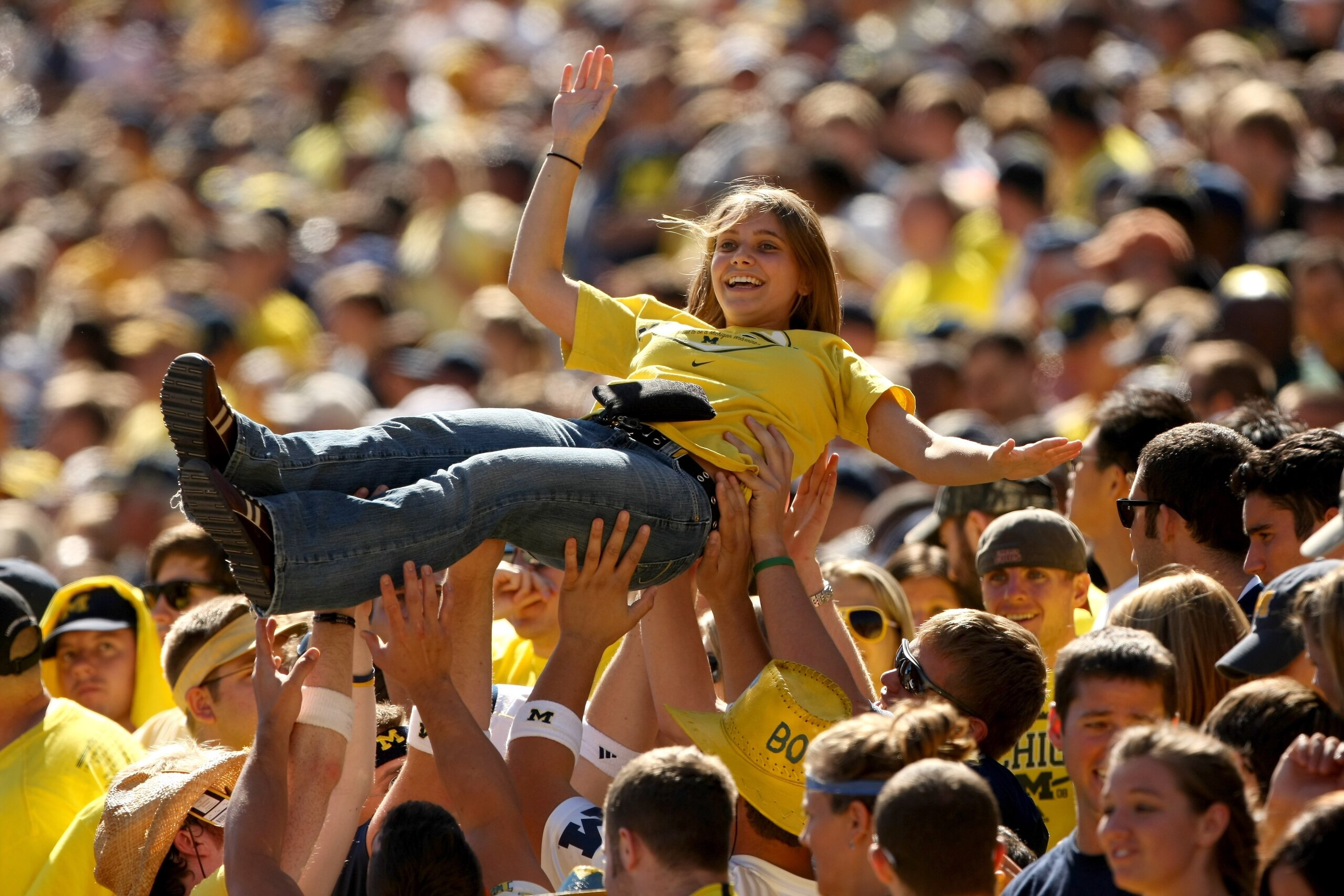 ANN ARBOR, MI - SEPTEMBER 19:  Members of the Michigan Wolverines student section lift a fan to celebrate a score against the Eastern Michigan Eagles at Michigan Stadium on September 19, 2009 in Ann Arbor, Michigan. Michigan won 45-17.  (Photo by Stephen