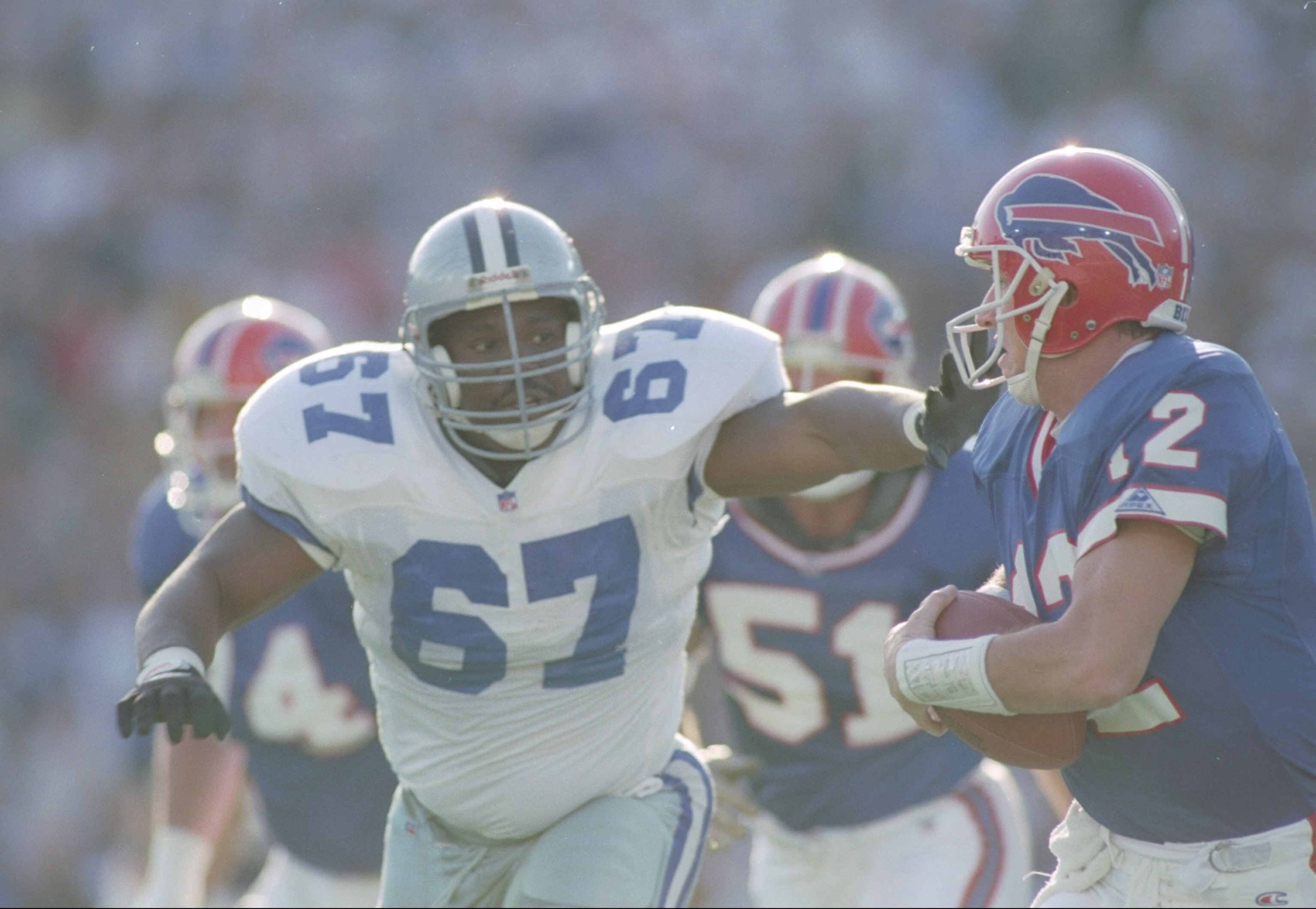 31 Jan 1993:  Defensive lineman Russell Maryland #67 of the Dallas Cowboys pressures quarterback Jim Kelly (right) of the Buffalo Bills to   surrender the ball during a Super Bowl XXVII game at the Rose Bowl in Pasadena, California.  The Cowboys won over