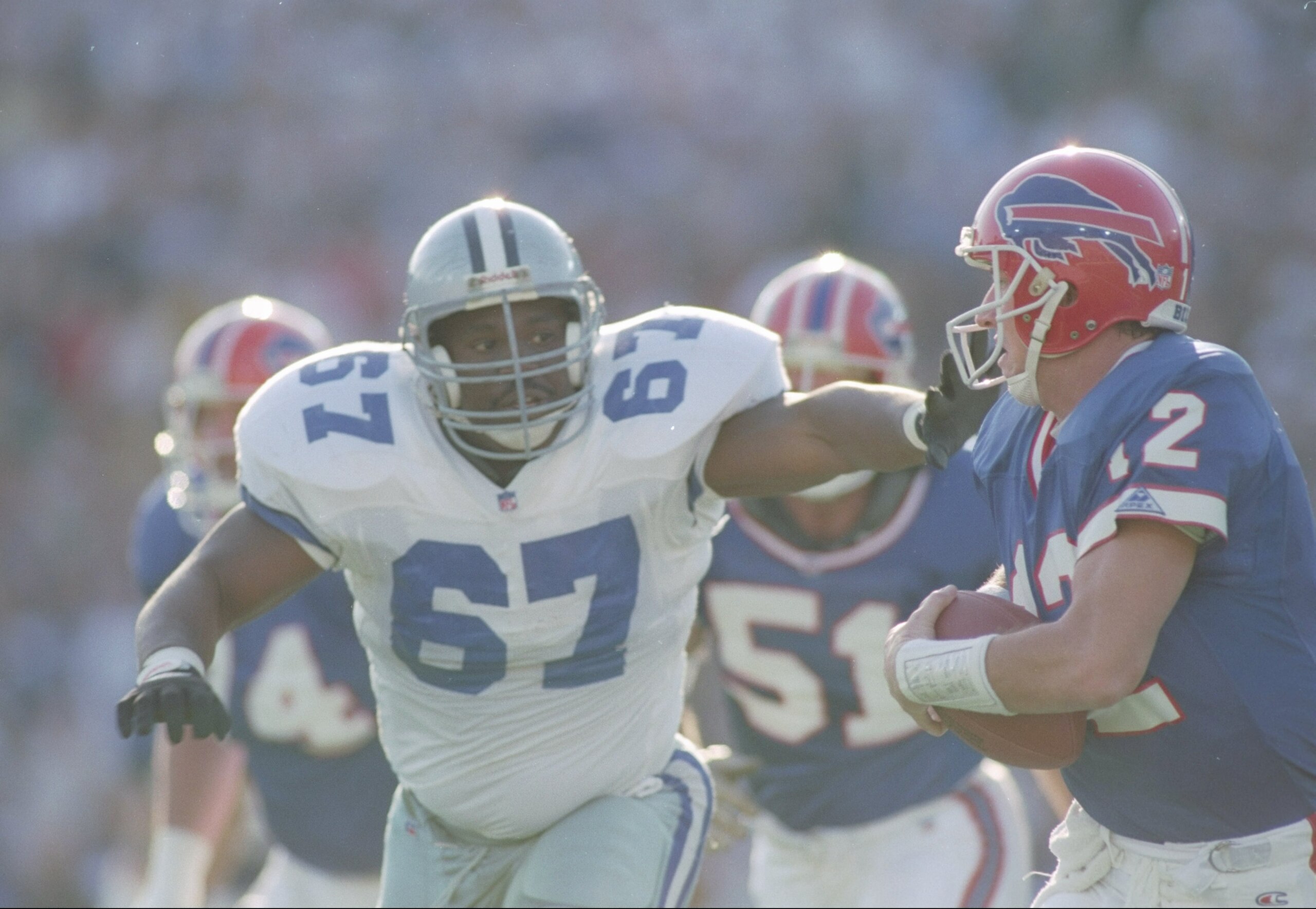 31 Jan 1993:  Defensive lineman Russell Maryland #67 of the Dallas Cowboys pressures quarterback Jim Kelly (right) of the Buffalo Bills to   surrender the ball during a Super Bowl XXVII game at the Rose Bowl in Pasadena, California.  The Cowboys won over