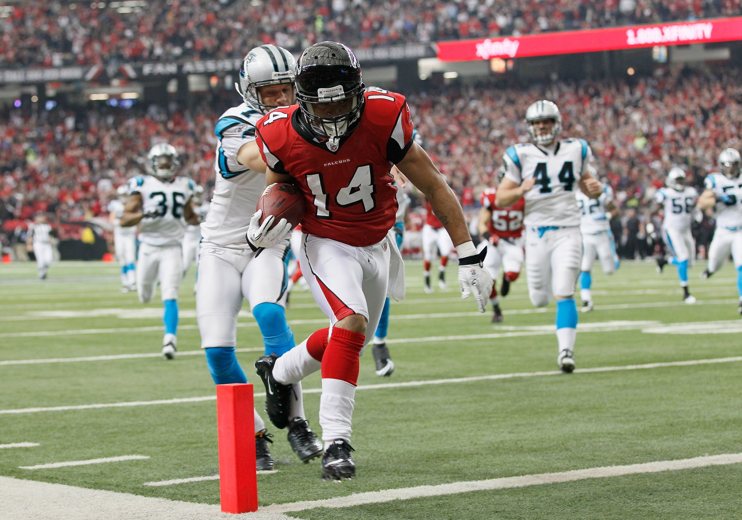ATLANTA, GA - JANUARY 02:  Eric Weems #14 of the Atlanta Falcons scores a touchdown on a punt return past Jason Baker #7 of the Carolina Panthers at Georgia Dome on January 2, 2011 in Atlanta, Georgia.  (Photo by Kevin C. Cox/Getty Images)