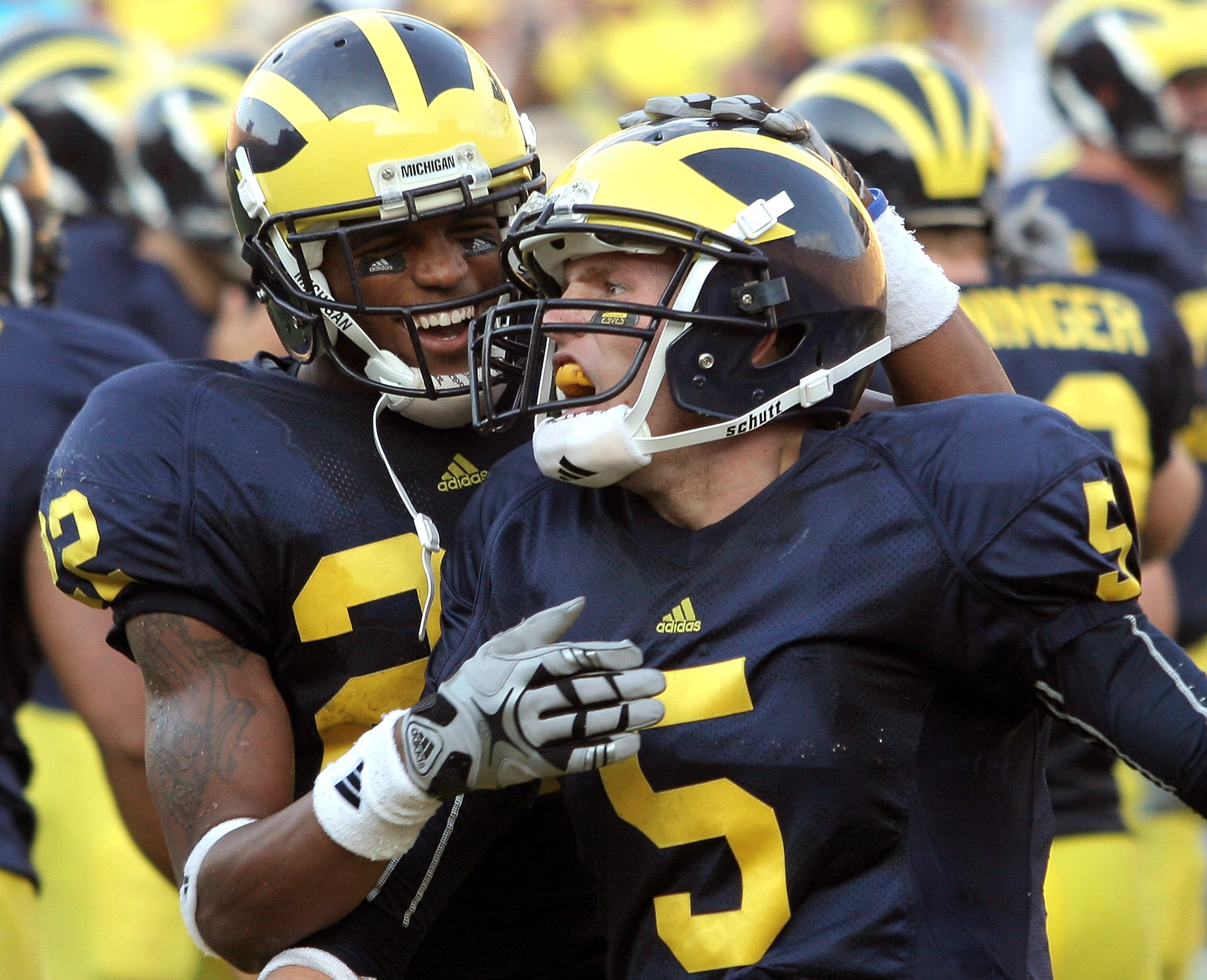 ANN ARBOR, MI - SEPTEMBER 12:  Quarterback Tate Forcier #5 of Michigan gets congratulated by teammate Darryl Stonum #22 after Forcier scored a touchdown late in the fourth quarter against Notre Dame at Michigan Stadium on September 12, 2009 in Ann Arbor,