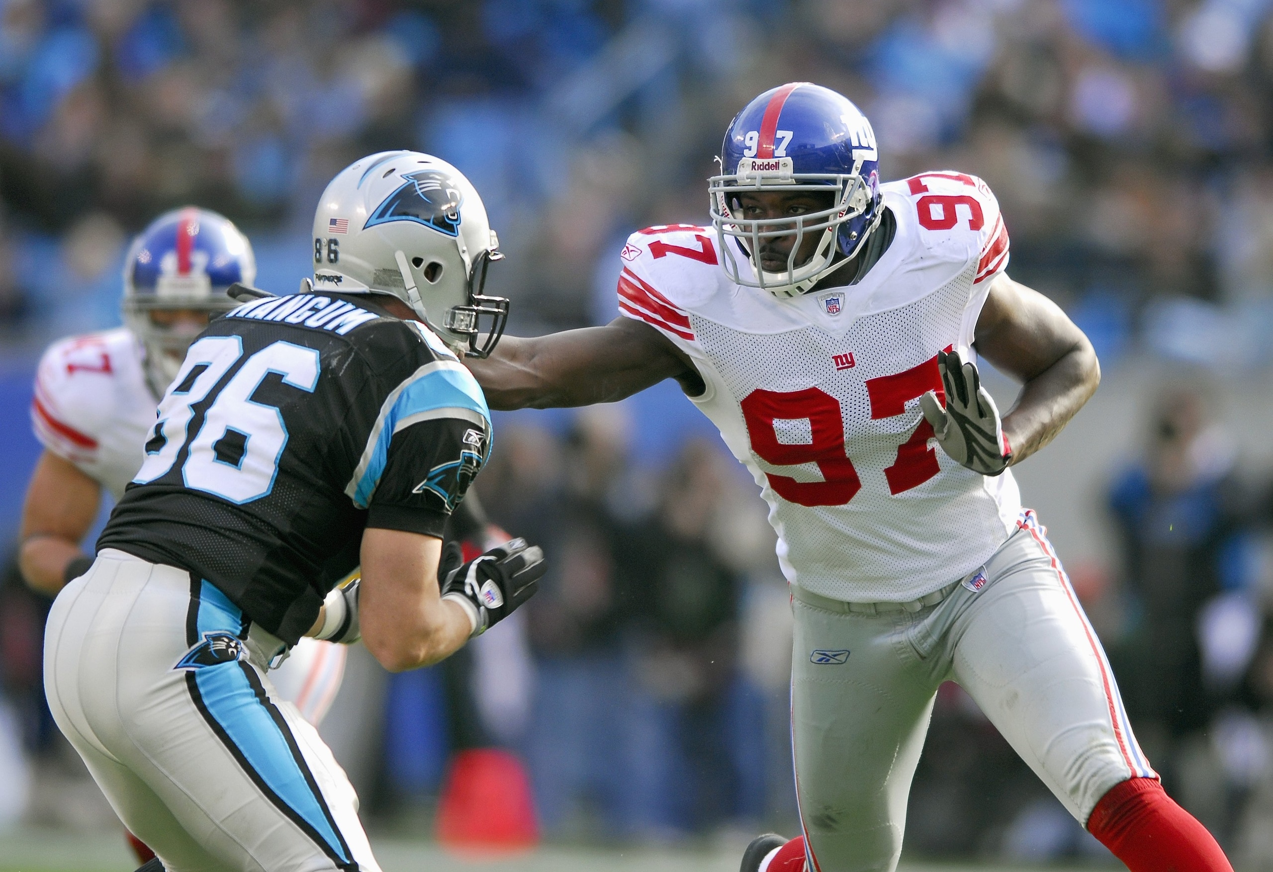 CHARLOTTE, NC - DECEMBER 10: Mathias Kiwanuka #97 of the New York Giants looks to block Kris Mangum #86 of the Carolina Panthers on December 10, 2006, at Bank of America Stadium in Charlotte, North Carolina. (Photo By Grant Halverson/Getty Images)