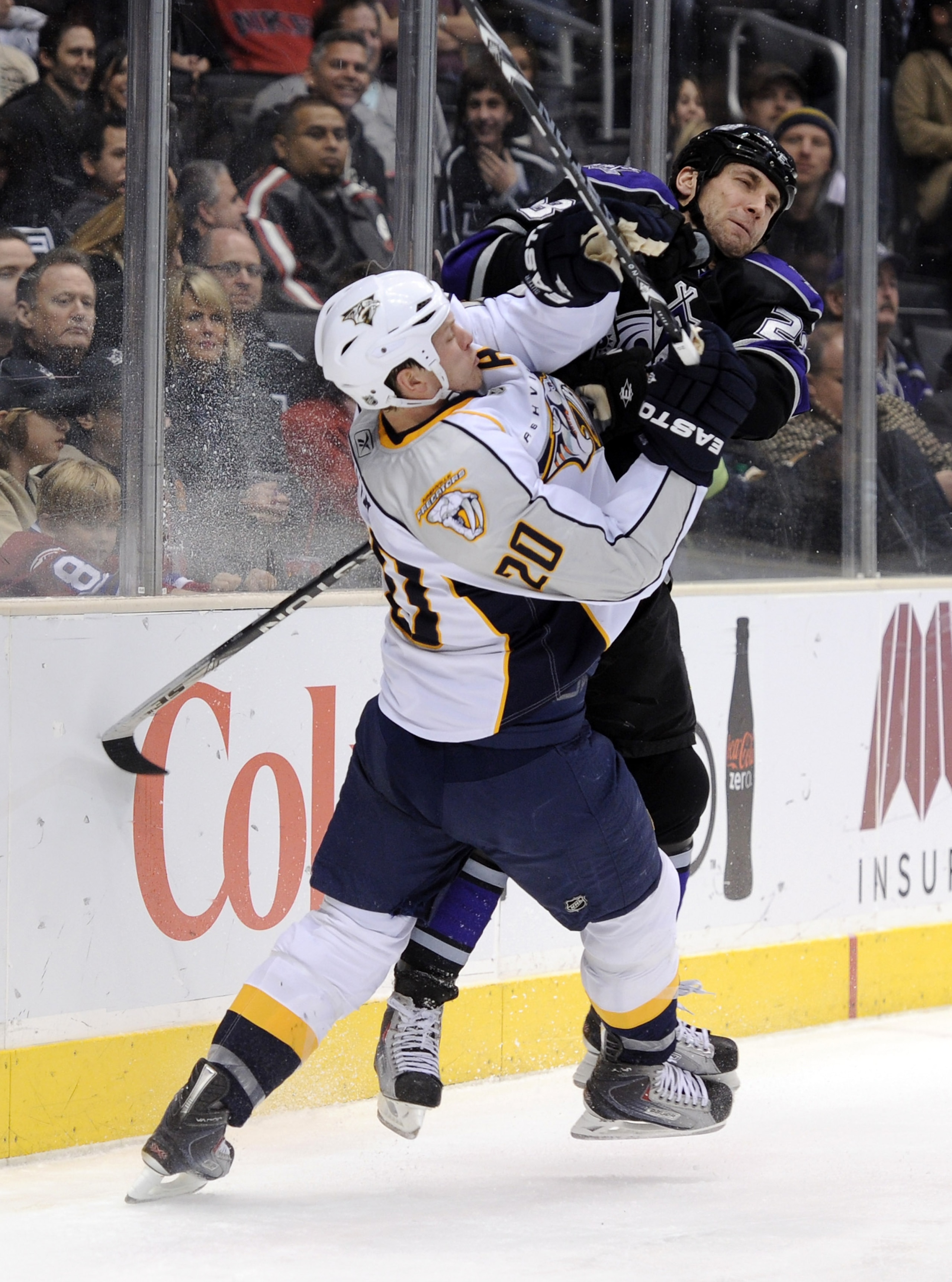 LOS ANGELES, CA - JANUARY 06:  Jarret Stoll #28 of the Los Angeles Kings puts a check on Ryan Suter #20 of the Nashville Predators during the second period at the Staples Center on January 6, 2011 in Los Angeles, California.  (Photo by Harry How/Getty Ima