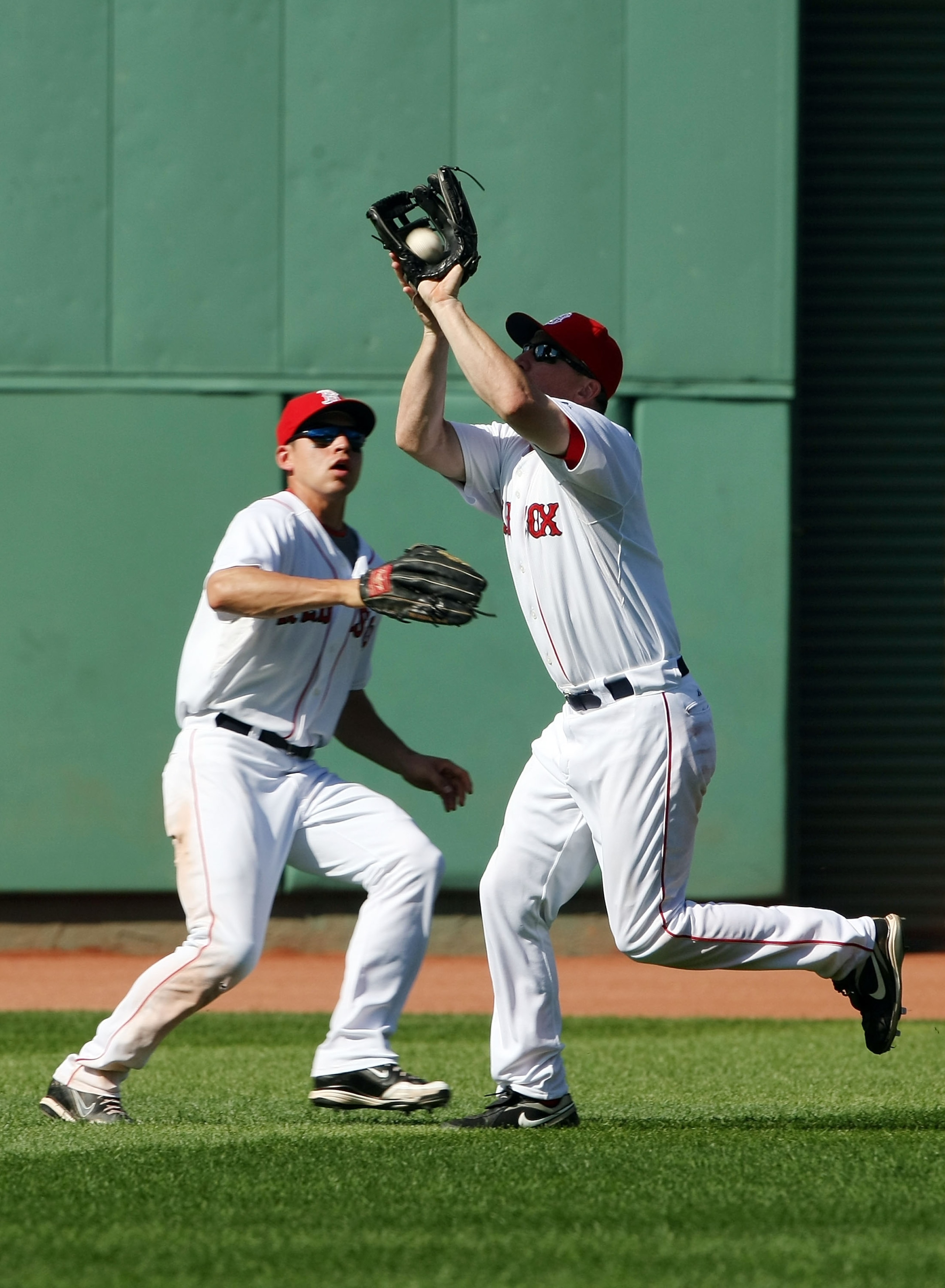 BOSTON - JULY 05: J.D. Drew #7 of the Boston Red Sox makes the catch for the out as teammate Jacoby Ellsbury #46 looks on in the ninth inning against the Seattle Mariners on July 5, 2009 at Fenway Park in Boston, Massachusetts. The Red Sox defeated the M BOSTON - JULY 05: J.D. Drew #7 of the Boston Red Sox makes the catch for the out as teammate Jacoby Ellsbury #46 looks on in the ninth inning against the Seattle Mariners on July 5, 2009 at Fenway Park in Boston, Massachusetts. The Red Sox defeated the M