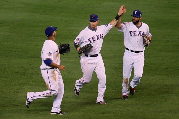 ARLINGTON, TX - OCTOBER 30:  (L-R) Nelson Cruz #17, Josh Hamilton #32 and Jeff Francoeur #21 of the Texas Rangers celebrate after their 4-2 win against the San Francisco Giants in Game Three of the 2010 MLB World Series at Rangers Ballpark in Arlington on