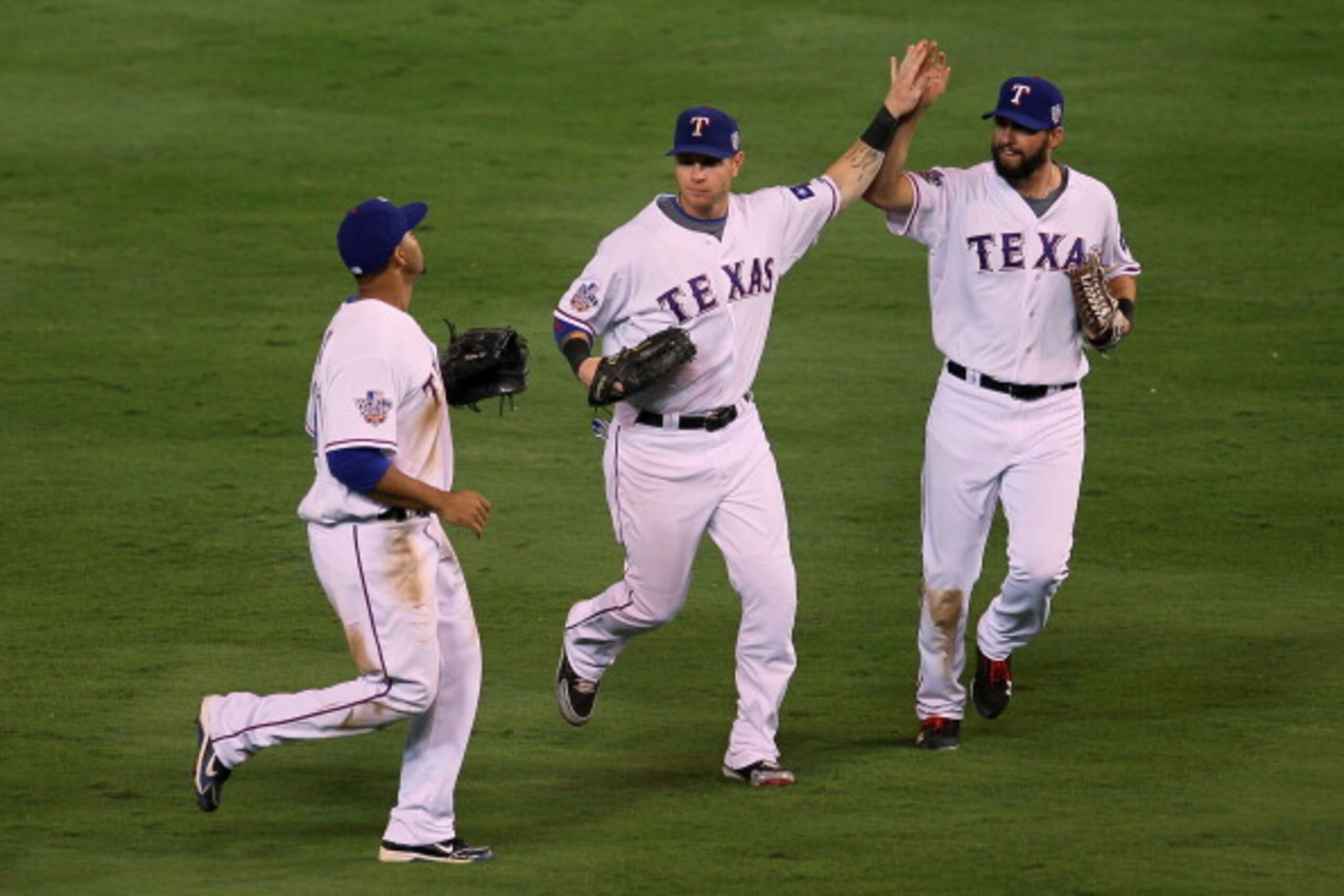 ARLINGTON, TX - OCTOBER 30: (L-R) Nelson Cruz #17, Josh Hamilton #32 and Jeff Francoeur #21 of the Texas Rangers celebrate after their 4-2 win against the San Francisco Giants in Game Three of the 2010 MLB World Series at Rangers Ballpark in Arlington on ARLINGTON, TX - OCTOBER 30: (L-R) Nelson Cruz #17, Josh Hamilton #32 and Jeff Francoeur #21 of the Texas Rangers celebrate after their 4-2 win against the San Francisco Giants in Game Three of the 2010 MLB World Series at Rangers Ballpark in Arlington on