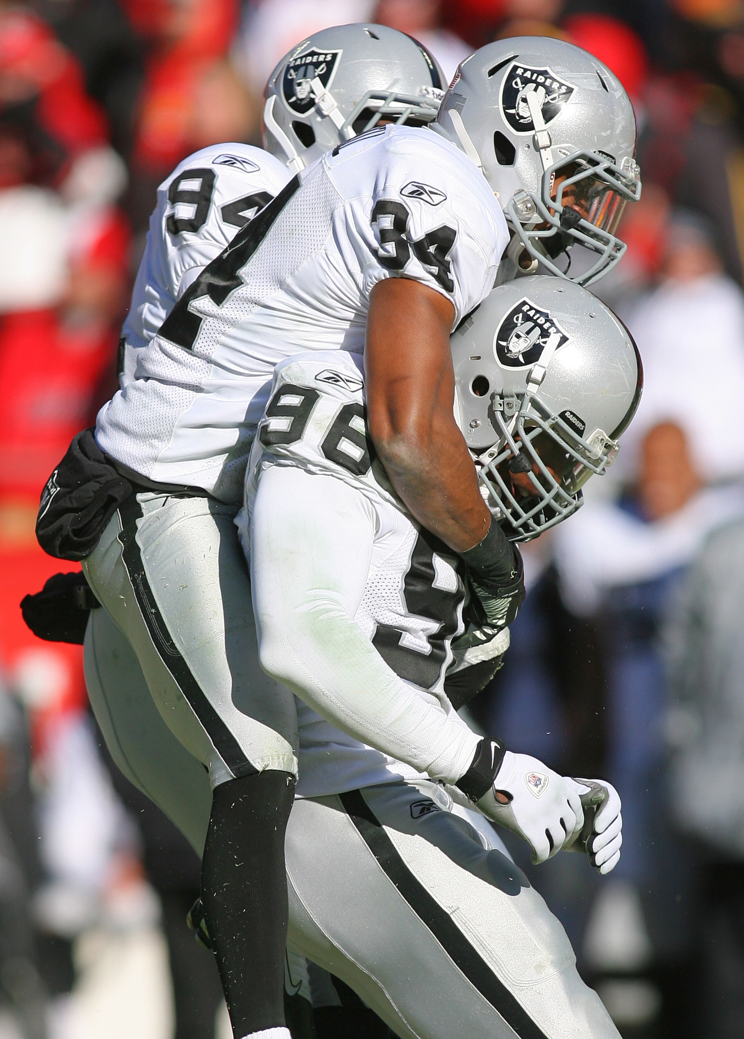 KANSAS CITY, MO - JANUARY 02:  Safety Mike Mitchell #34 of the Oakland Raiders congratulates linebacker Kamerion Wimbley #96 after a sack in a game against the Kansas City Chiefs at Arrowhead Stadium on January 2, 2011 in Kansas City, Missouri.  (Photo by