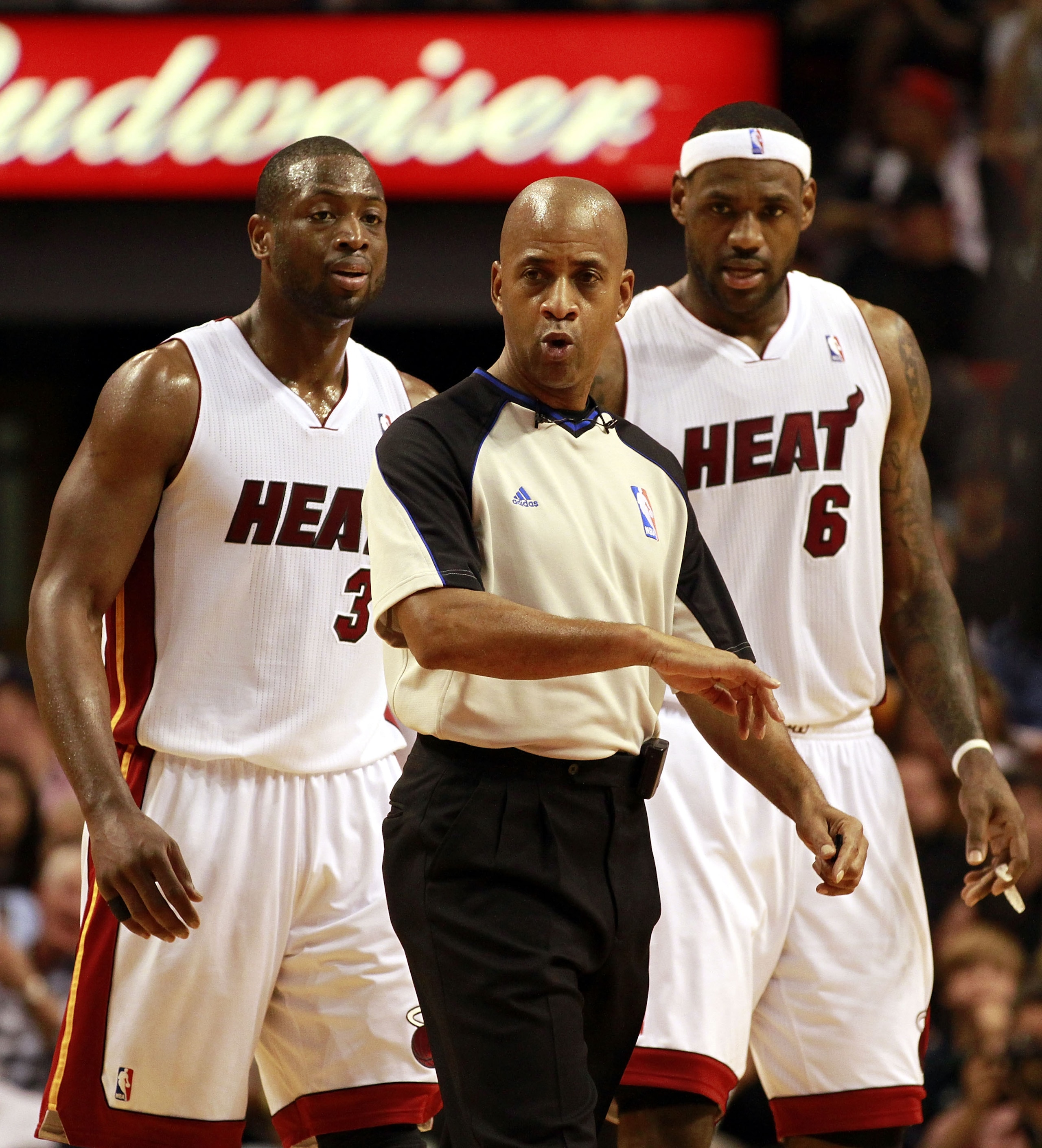 MIAMI - JANUARY 01: LeBron James #6 and Dwyane Wade #3 of the Miami Heat stand behind a referee during the game against the Golden State Warriors at American Airlines Arena on January 1, 2011 in Miami, Florida. The Heat won 114-107. NOTE TO USER: User exp