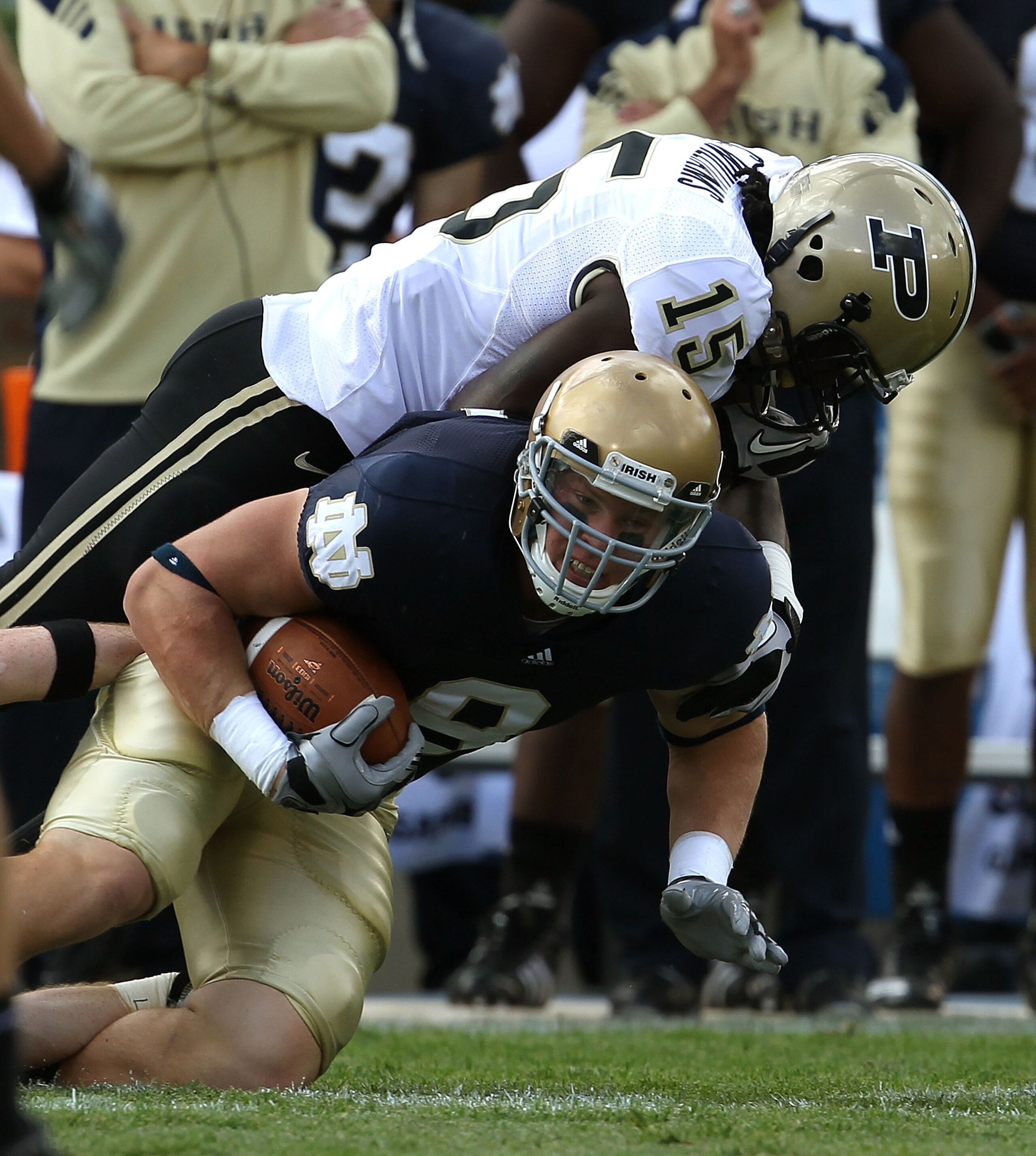 SOUTH BEND, IN - SEPTEMBER 04: Kyle Rudolph #9 of the Notre Dame Fighting Irish is tackled by Charlton Williams #15 of the Purdue Boilermakers at Notre Dame Stadium on September 4, 2010 in South Bend, Indiana. Notre Dame defeated Purdue 23-12. (Photo by J SOUTH BEND, IN - SEPTEMBER 04: Kyle Rudolph #9 of the Notre Dame Fighting Irish is tackled by Charlton Williams #15 of the Purdue Boilermakers at Notre Dame Stadium on September 4, 2010 in South Bend, Indiana. Notre Dame defeated Purdue 23-12. (Photo by J