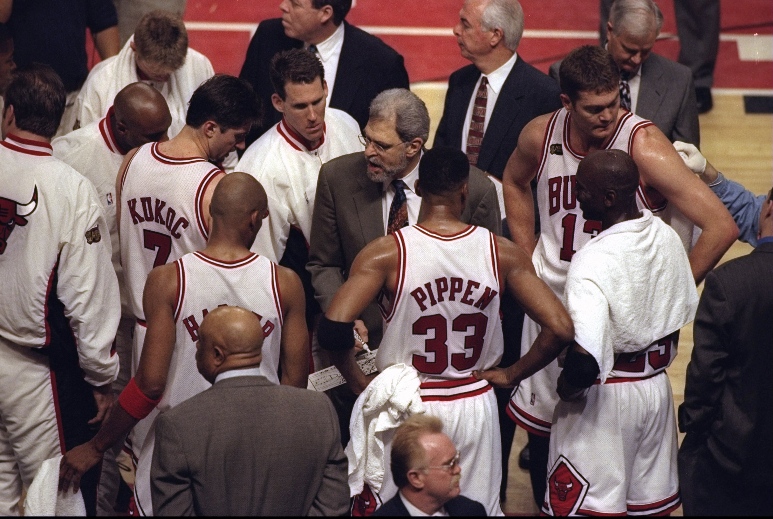 7 Jun 1998:  Coach Phil Jackson talks with Tony Kukoc, Jud Buechler, Luc Longley, Michael Jordan #23, Scottie Pippen #33, and Ron Harper of the Chicago Bulls during the NBA Finals Game 3 against the Utah Jazz at the United Center in Chicago, Illinois.  Th