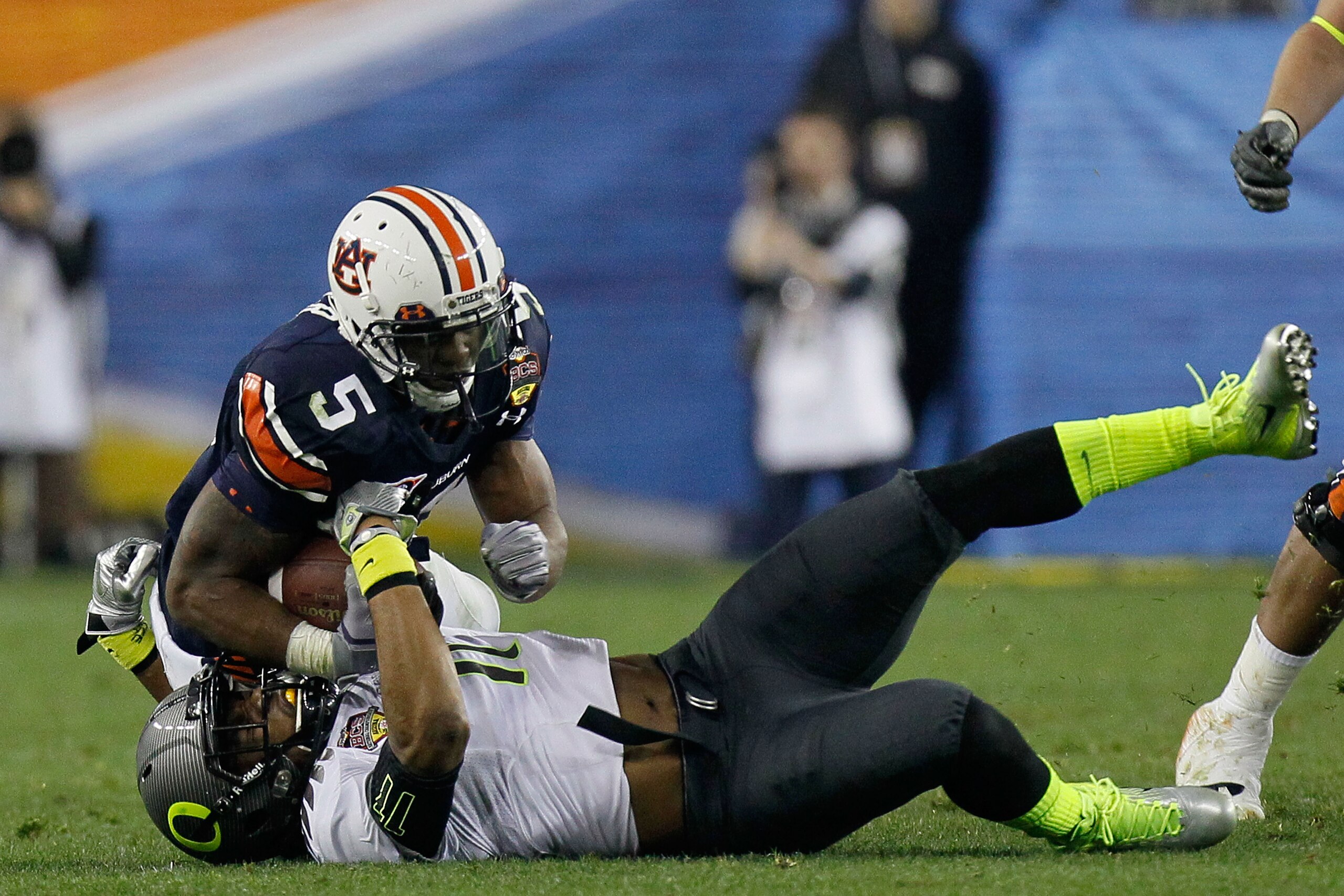 GLENDALE, AZ - JANUARY 10: Michael Dyer #5 of the Auburn Tigers rolls on top of Eddie Pleasant #11 of the Oregon Ducks and runs for a 37-yard run late in the fourth quarter during the Tostitos BCS National Championship Game at University of Phoenix Stadi GLENDALE, AZ - JANUARY 10: Michael Dyer #5 of the Auburn Tigers rolls on top of Eddie Pleasant #11 of the Oregon Ducks and runs for a 37-yard run late in the fourth quarter during the Tostitos BCS National Championship Game at University of Phoenix Stadi