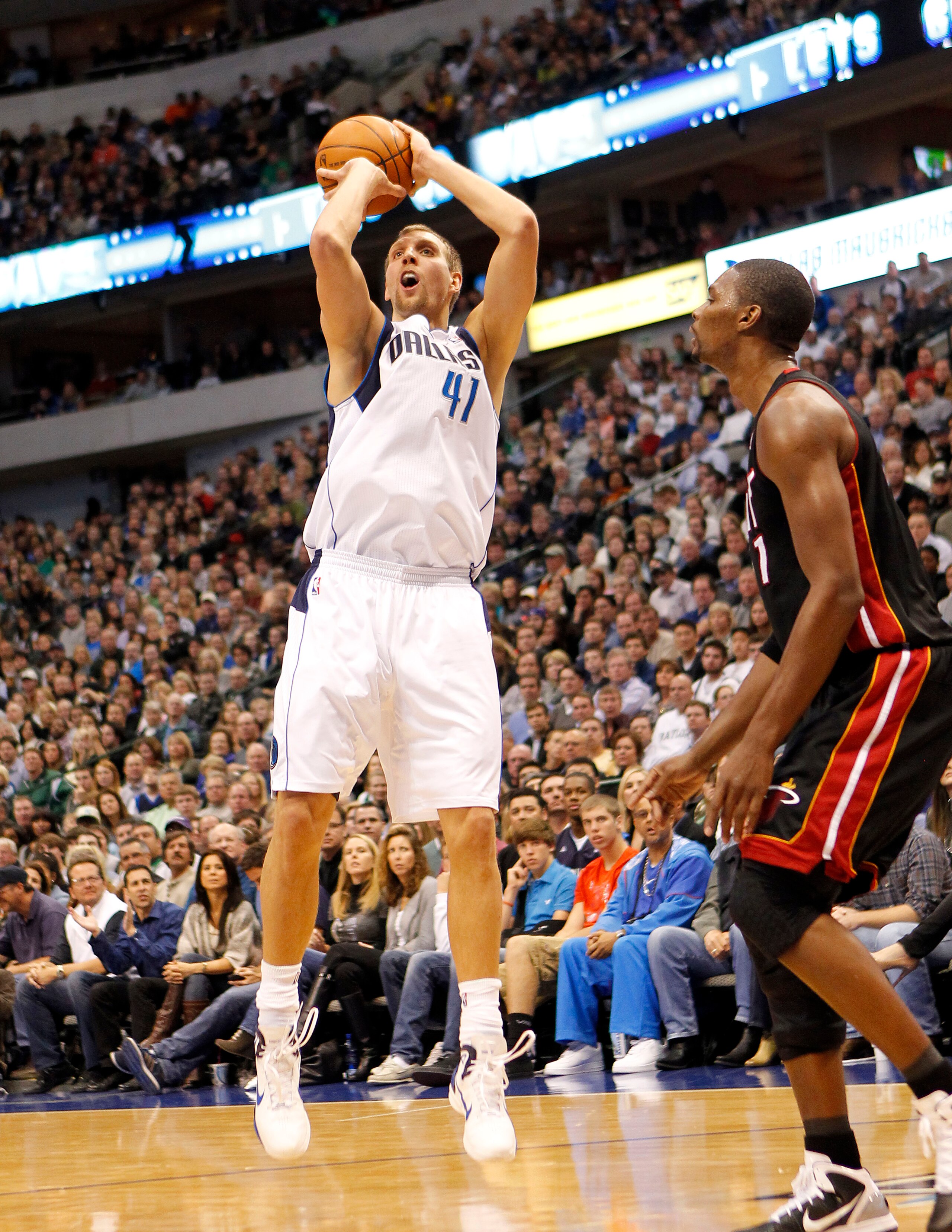 DALLAS - NOVEMBER 27: Dirk Nowitzki #41 of the Dallas Mavericks shoots over Chris Bosh #1 of the Miami Heat on November 27, 2010 at the American Airlines Center in Dallas, Texas. NOTE TO USER: User expressly acknowledges and agrees that, by downloading an DALLAS - NOVEMBER 27: Dirk Nowitzki #41 of the Dallas Mavericks shoots over Chris Bosh #1 of the Miami Heat on November 27, 2010 at the American Airlines Center in Dallas, Texas. NOTE TO USER: User expressly acknowledges and agrees that, by downloading an