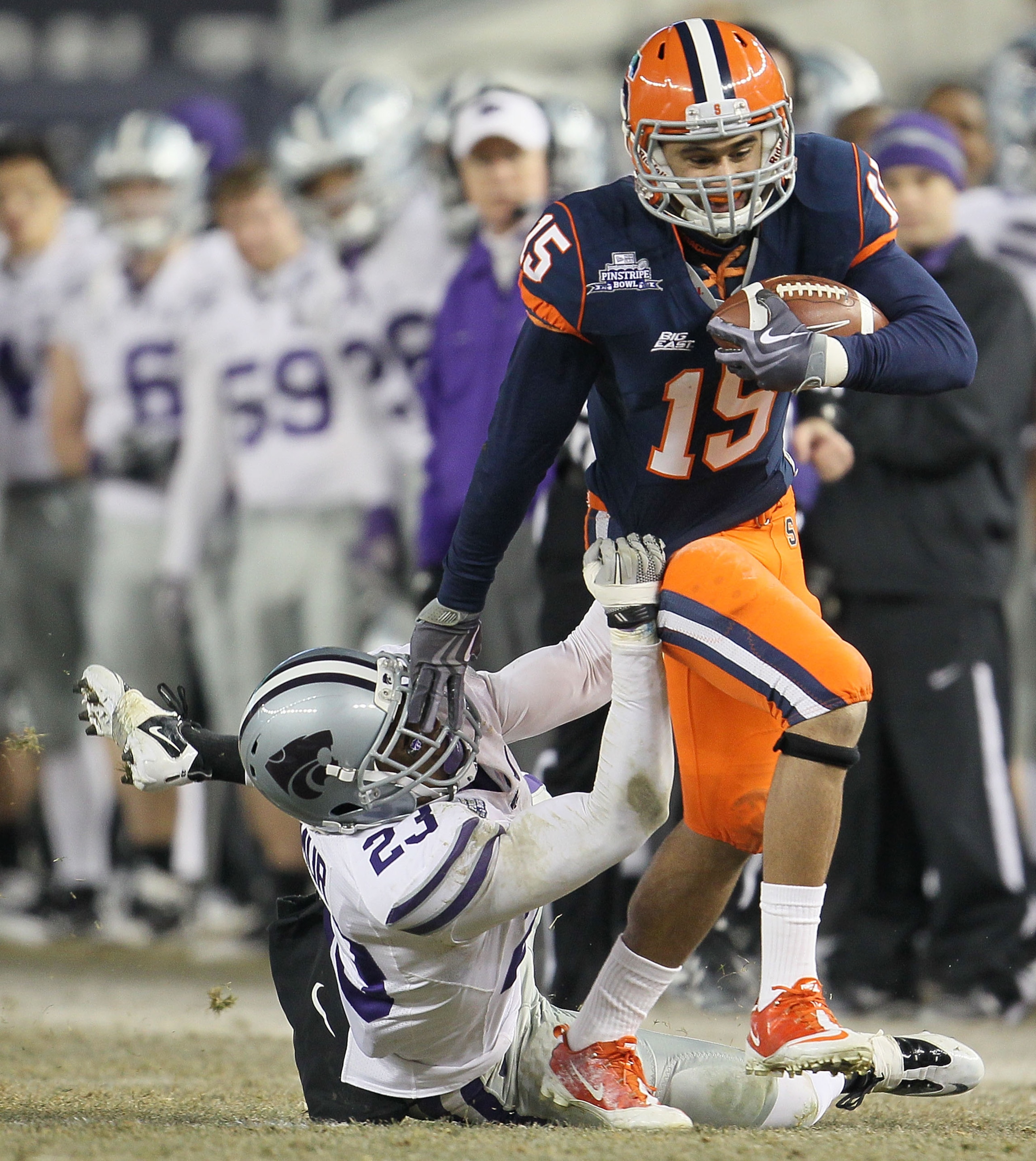 NEW YORK, NY - DECEMBER 30: Alec Lemon #15 of the Syracuse Orange is tackled by Emmanuel Lamur #23  of the Kansas State Wildcats during the New Era Pinstripe Bowl at Yankee Stadium on December 30, 2010 in New York, New York.  (Photo by Chris McGrath/Getty