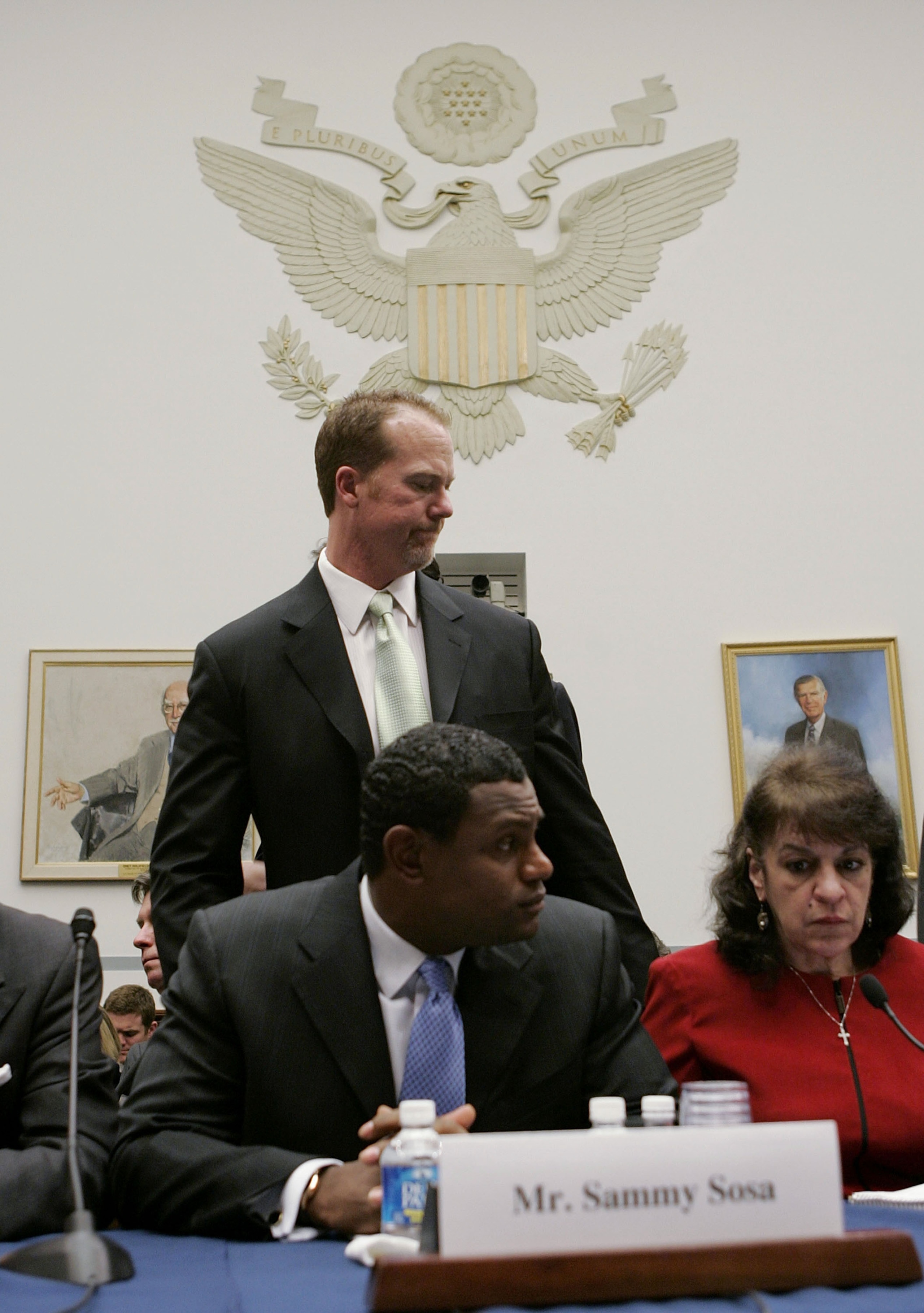 WASHINGTON - MARCH 17:  Former St. Louis Cardinal Mark McGwire passes behind Baltimore Oriole Sammy Sosa during a House Committe session investigating Major League Baseball's effort to eradicate steroid use on Capital Hill March 17, 2005 in Washington, DC