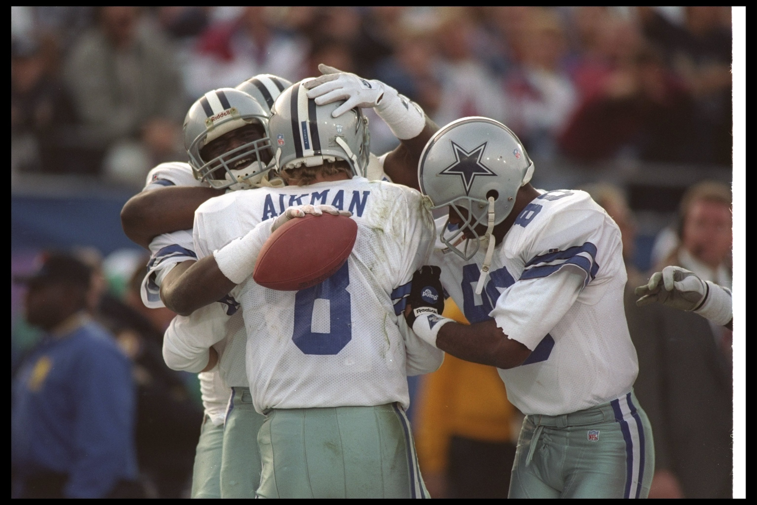 31 Jan 1993:  Quarterback Troy Aikman of the Dallas Cowboys celebrates with teammates during Super Bowl XXVII against the Buffalo Bills at the Rose Bowl in Pasadena, California.  The Cowboys won the game, 52-17. Mandatory Credit: Stephen Dunn  /Allsport