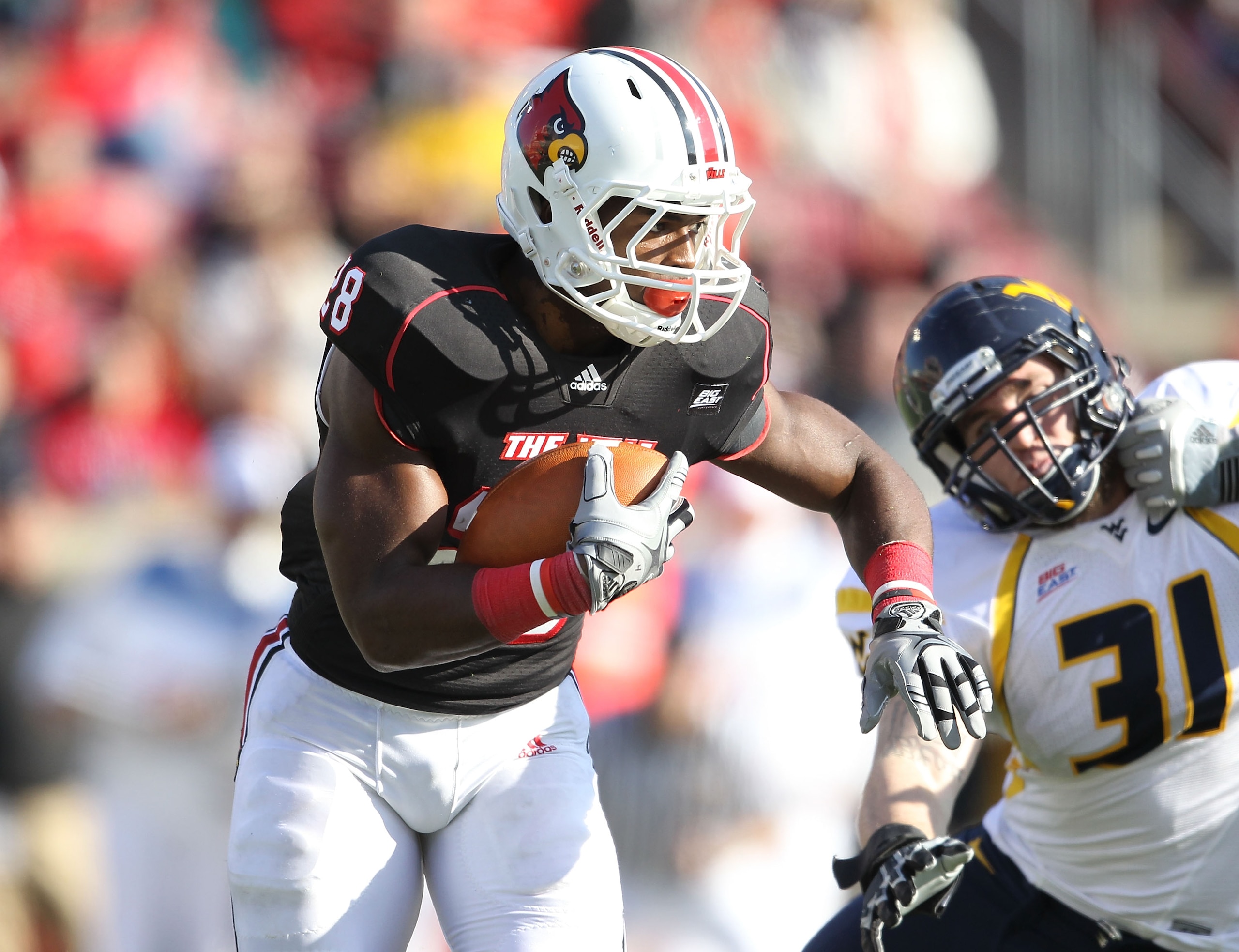 LOUISVILLE, KY - NOVEMBER 20:  Jeremy Wright #28 of the Louisville Cardinals runs with the ball during the Big East Conference game against the West Virginia Mountaineers at Papa John's Cardinal Stadium on November 20, 2010 in Louisville, Kentucky.  (Phot