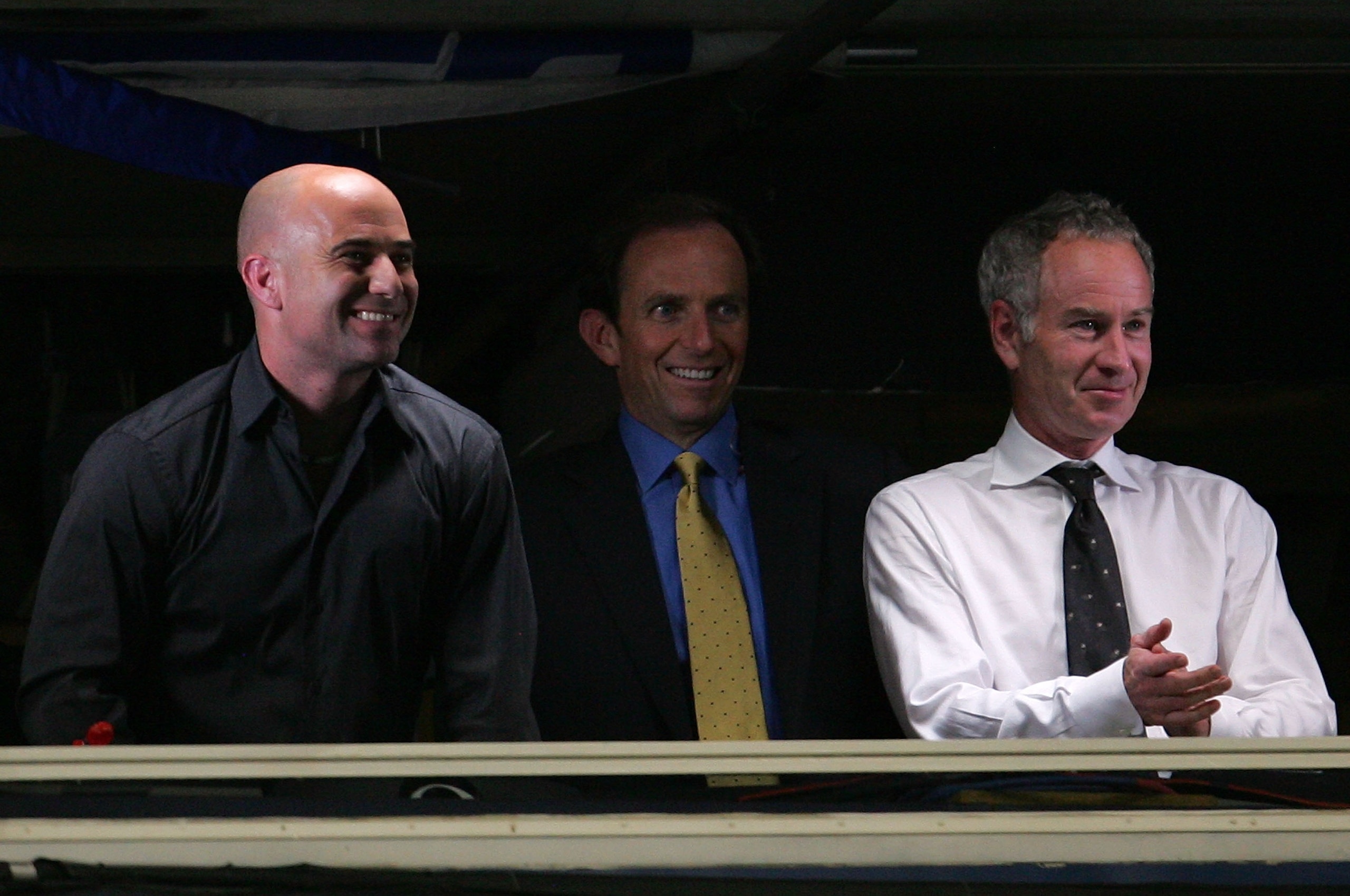 NEW YORK - SEPTEMBER 05:  (L-R) Andre Agassi, Ted Robinson and John McEnroe broadcast from the USA network booth as Andy Roddick plays against Roger Federer during day ten of the 2007 U.S. Open at the Billie Jean King National Tennis Center on September 5