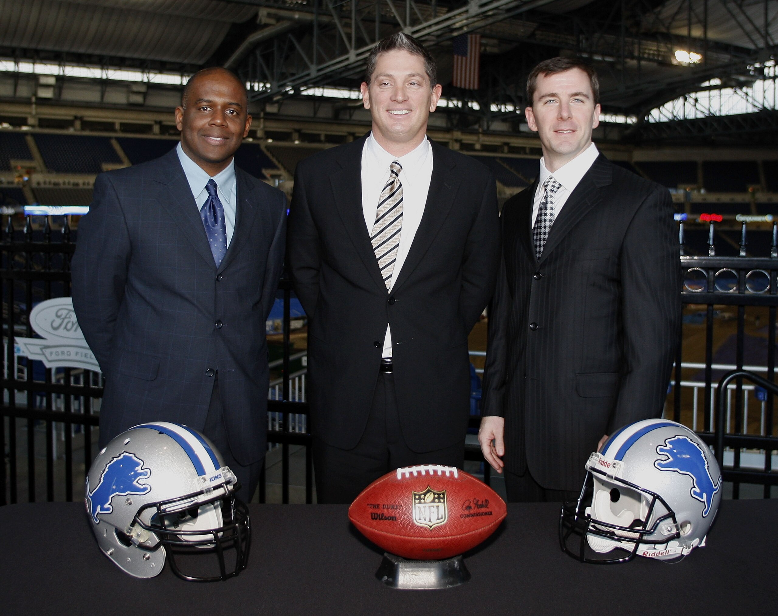 DETROIT , MI - JANUARY 16: Jim Schwartz, center, head coach of the Detroit Lions poses with General Manager Martin Mayhew, left, and Tom Lewand team president after a press conference to introduce him as the Lions new head coach on January 16, 2009 at Fo DETROIT , MI - JANUARY 16: Jim Schwartz, center, head coach of the Detroit Lions poses with General Manager Martin Mayhew, left, and Tom Lewand team president after a press conference to introduce him as the Lions new head coach on January 16, 2009 at Fo