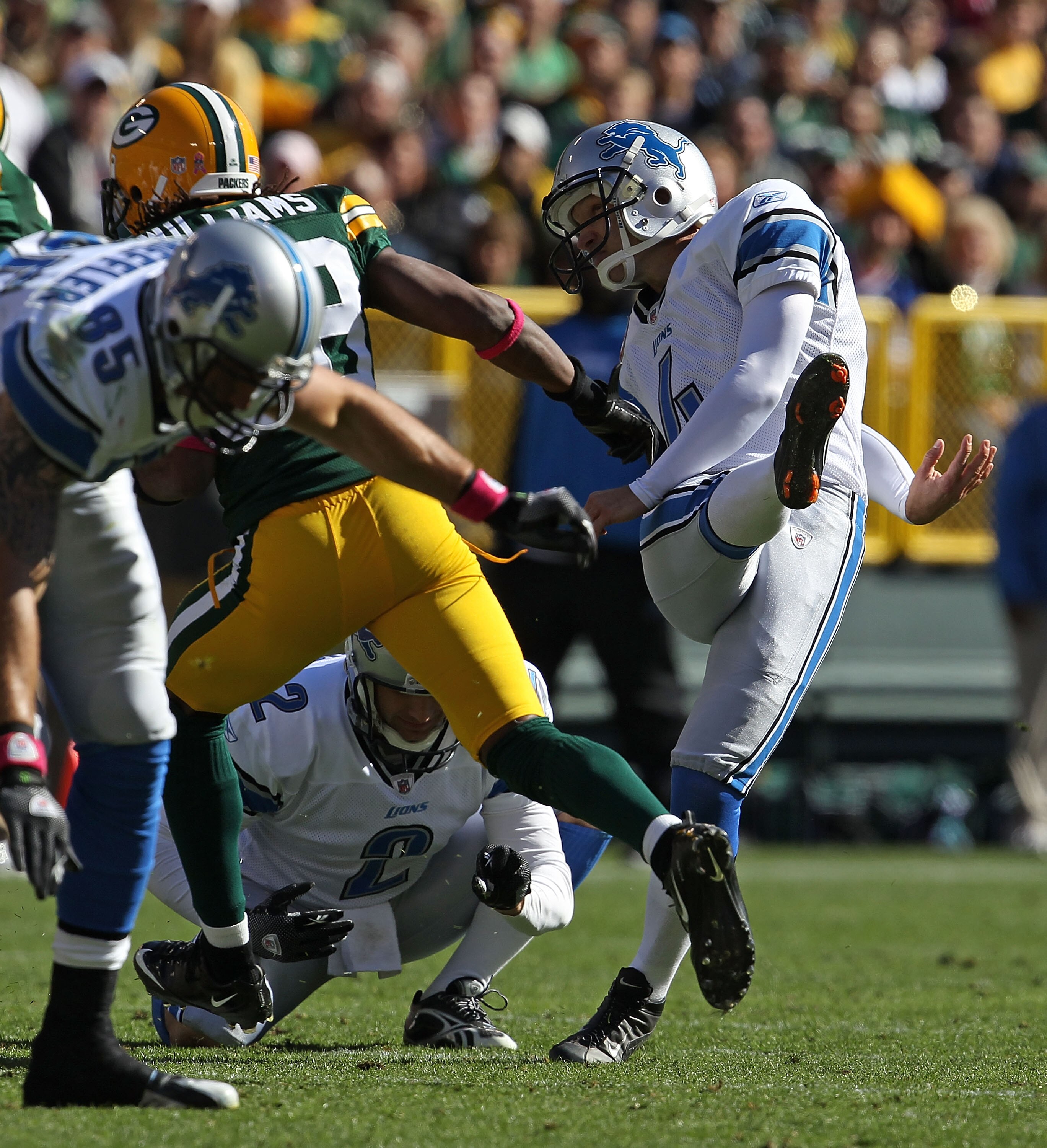 GREEN BAY, WI - OCTOBER 03: Jason Hanson #4 of the Detroit Lions kicks a 52 yard field goal out of the hold of Nick Harris #2 against the Green Bay Packers at Lambeau Field on October 3, 2010 in Green Bay, Wisconsin. The Packers defeated the Lions 28-26.
