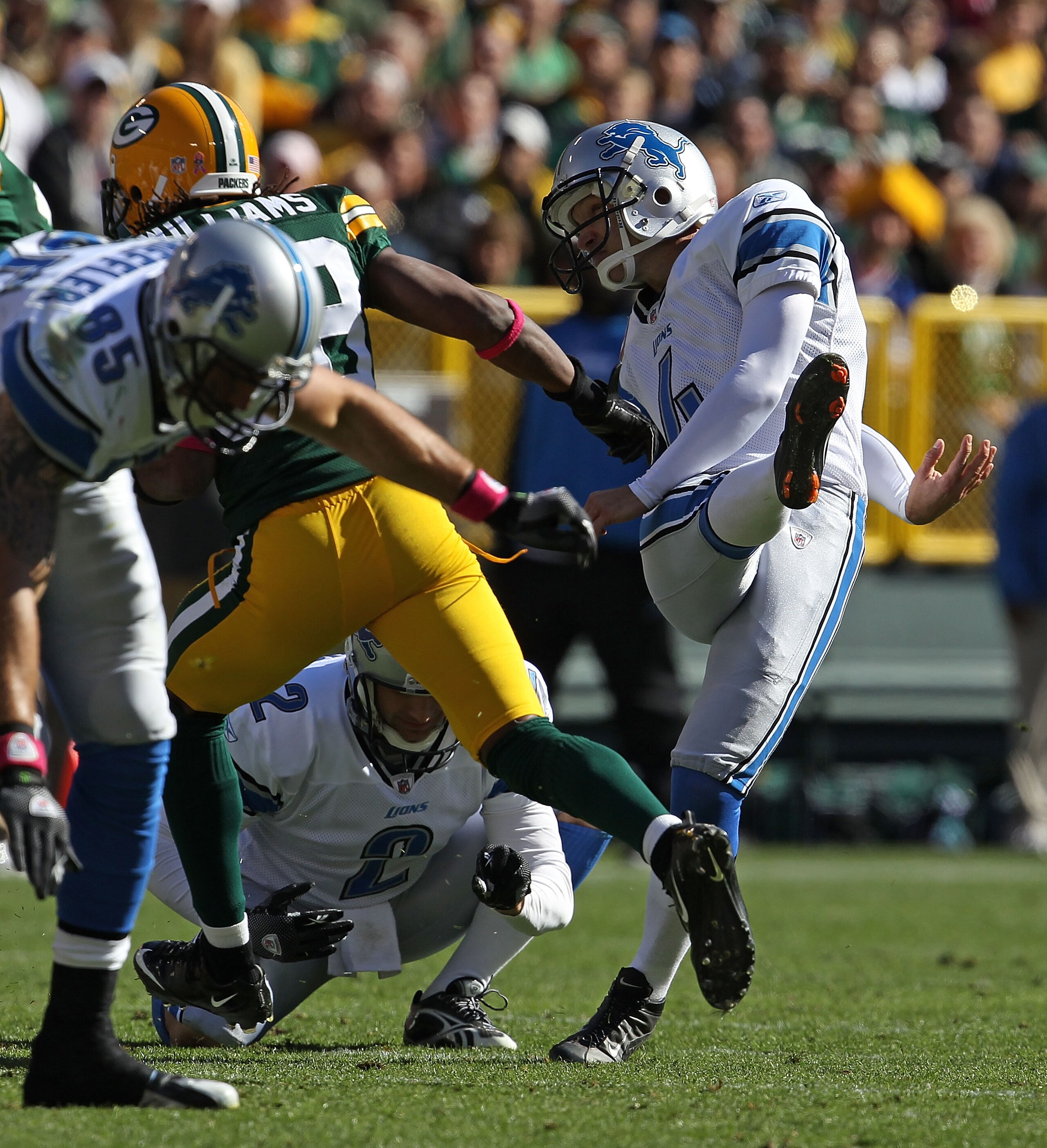GREEN BAY, WI - OCTOBER 03: Jason Hanson #4 of the Detroit Lions kicks a 52 yard field goal out of the hold of Nick Harris #2 against the Green Bay Packers at Lambeau Field on October 3, 2010 in Green Bay, Wisconsin. The Packers defeated the Lions 28-26. GREEN BAY, WI - OCTOBER 03: Jason Hanson #4 of the Detroit Lions kicks a 52 yard field goal out of the hold of Nick Harris #2 against the Green Bay Packers at Lambeau Field on October 3, 2010 in Green Bay, Wisconsin. The Packers defeated the Lions 28-26.
