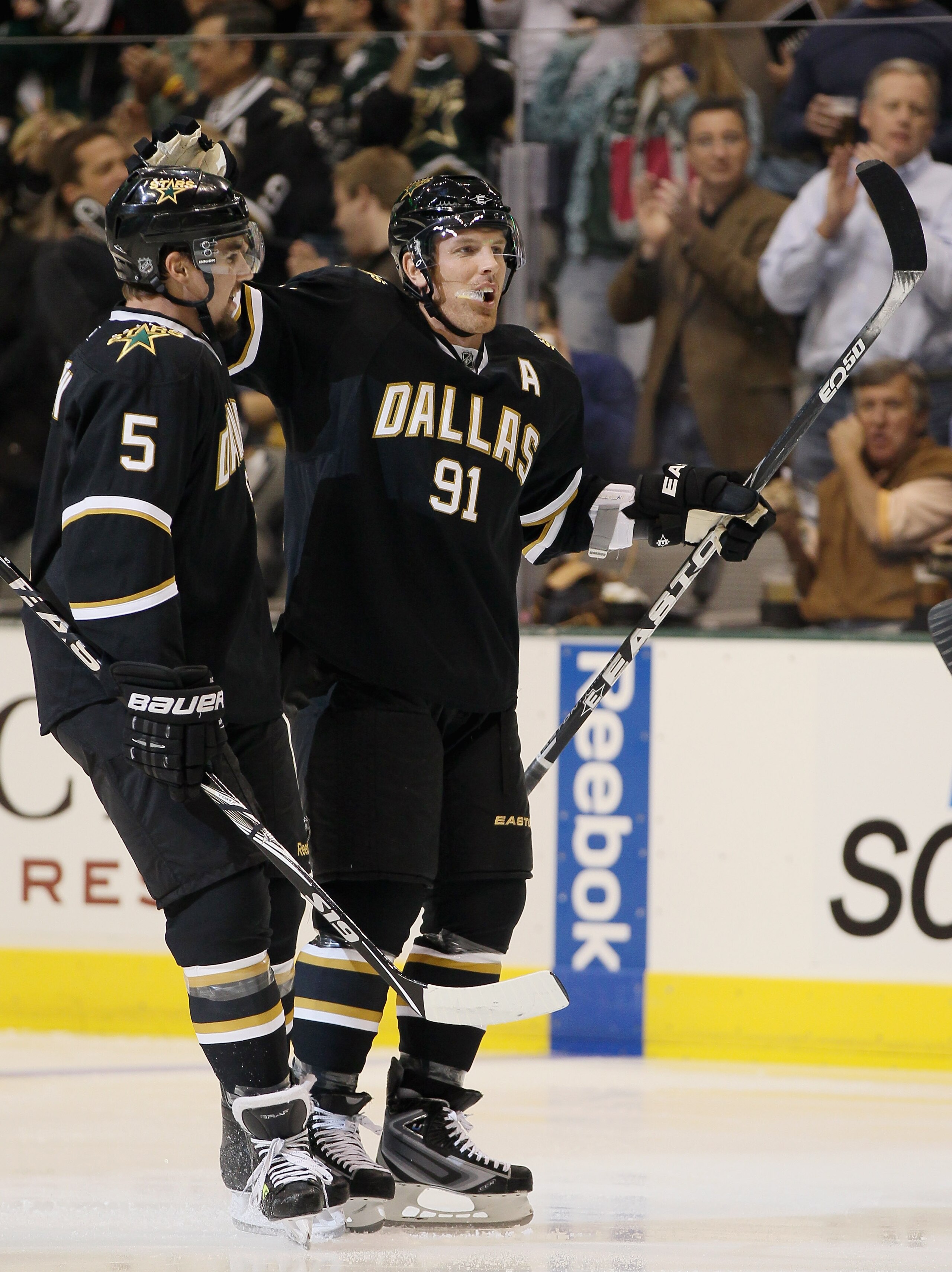 DALLAS - OCTOBER 14:  Brad Richards #91 of the Dallas Stars is congratulated by teammate Matt Niskanen #5 after Richards scored in the first period agianst the Detroit Red Wings on October 14, 2010 at the American Airlines Center in Dallas, Texas.  (Photo