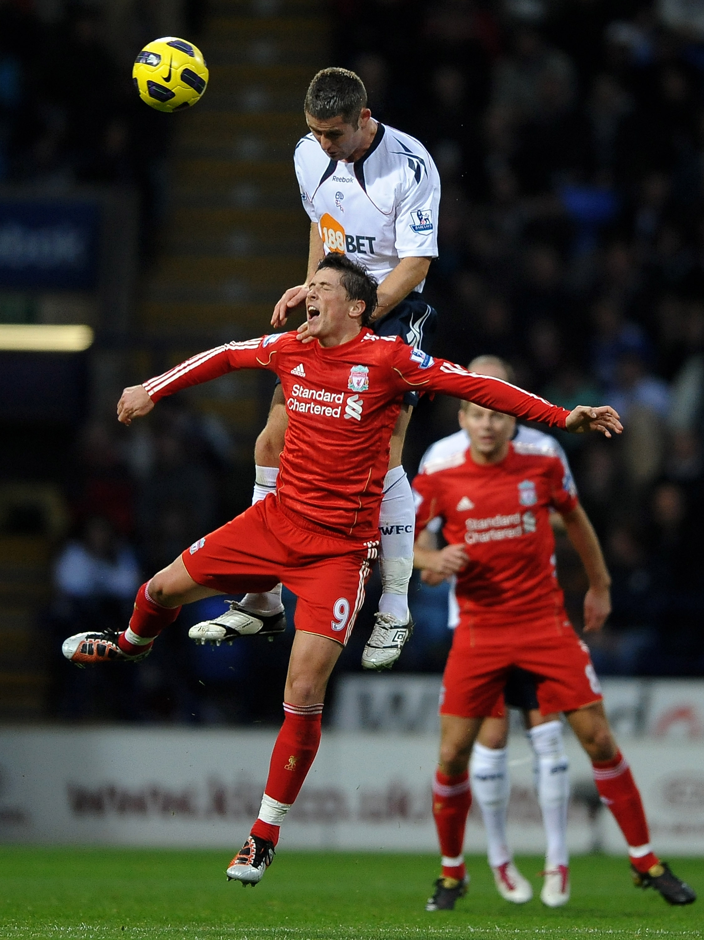 BOLTON, ENGLAND - OCTOBER 31:  Fernando Torres of Liverpool tangles with Gary Cahill of Bolton Wanderers during the Barclays Premier League match between Bolton Wanderers and Liverpool at the Reebok Stadium on October 31, 2010 in Bolton, England. (Photo b