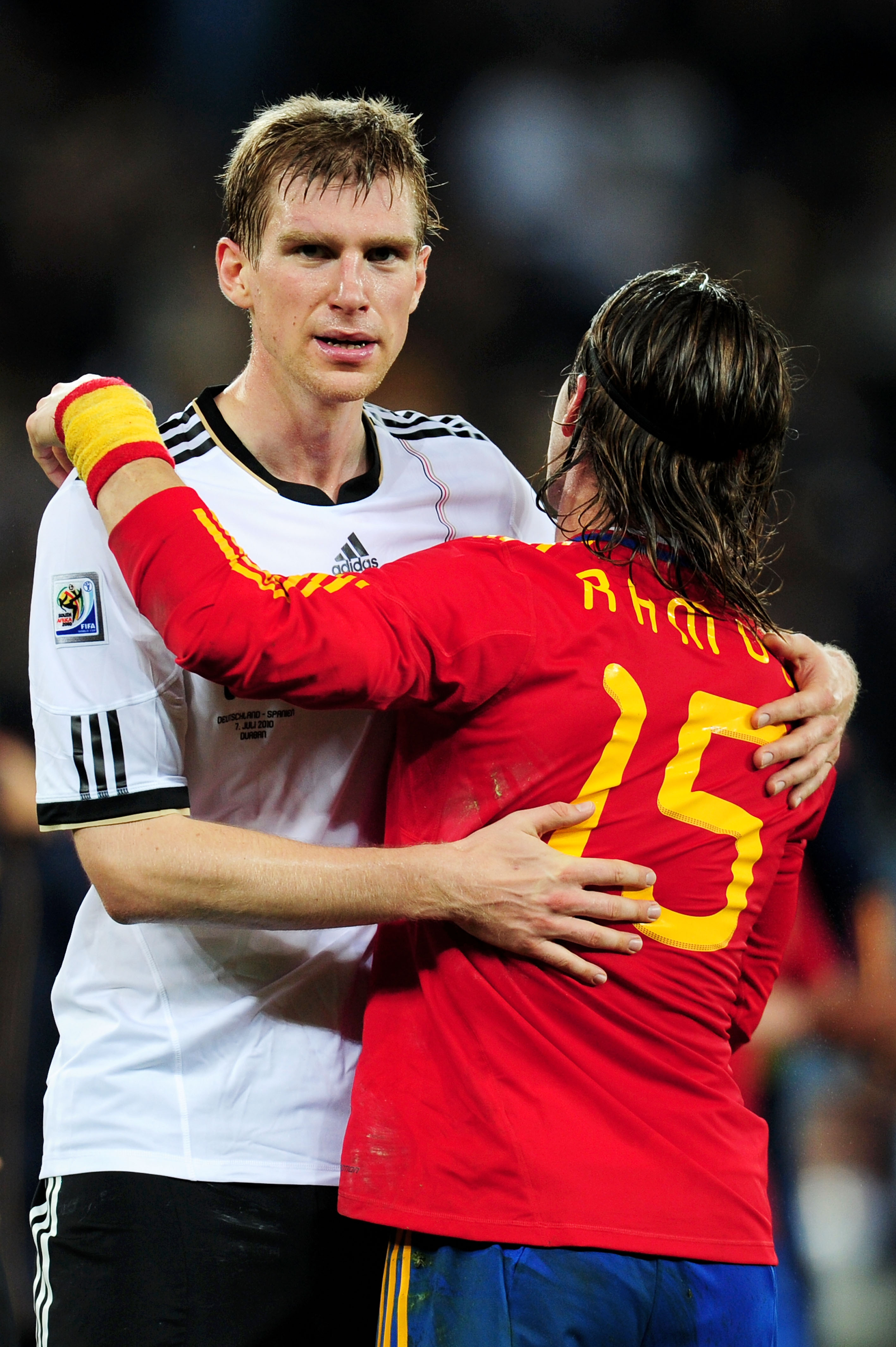 DURBAN, SOUTH AFRICA - JULY 07:  Dejected Per Mertesacker after being knocked out of the tournament is consoled by Sergio Ramos of Spain during the 2010 FIFA World Cup South Africa Semi Final match between Germany and Spain at Durban Stadium on July 7, 20