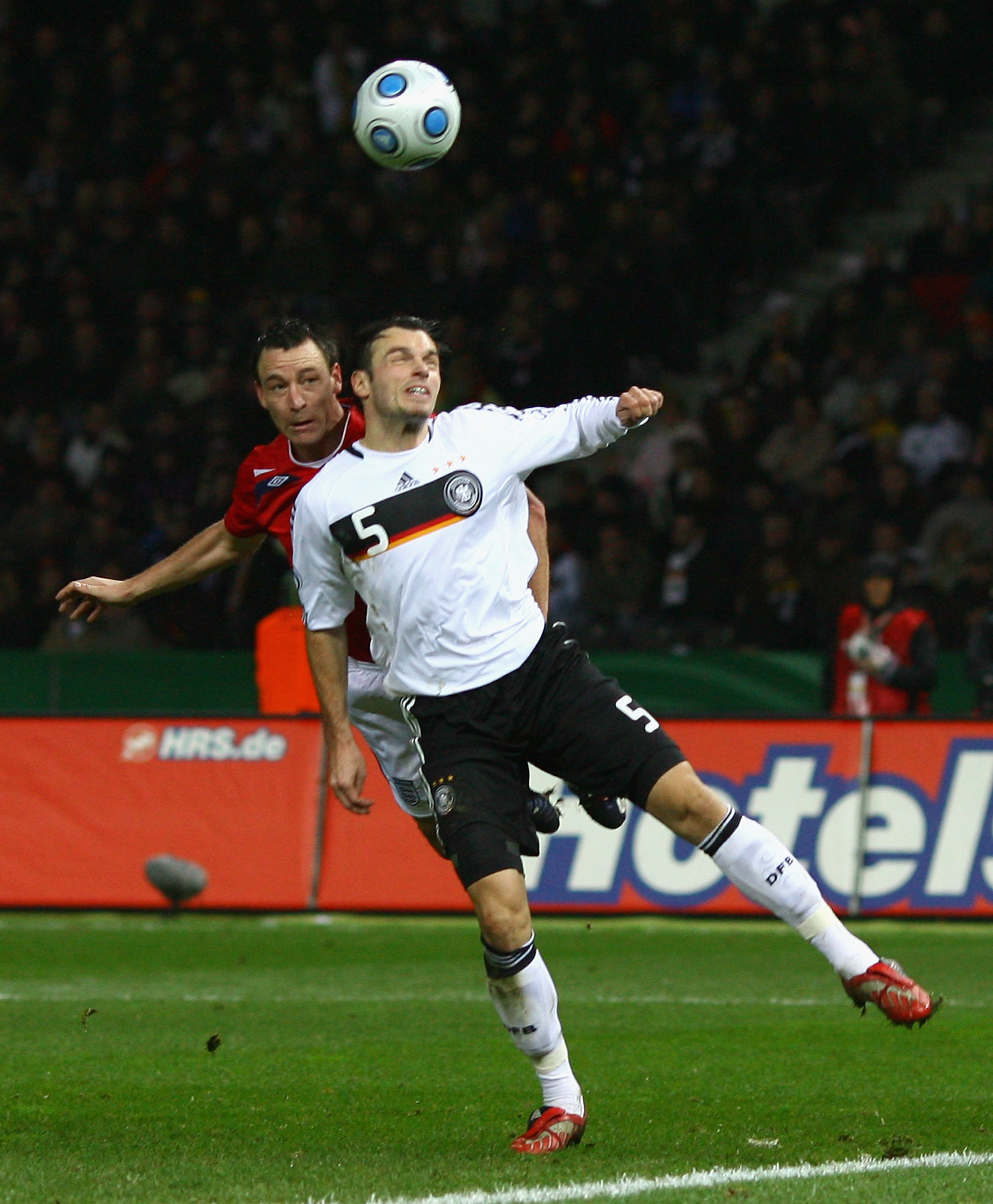 BERLIN - NOVEMBER 19:  John Terry of England rises to head his team's second goal past Heiko Westermann of Germany during the International Friendly match between Germany and England at the Olympic Stadium on November 19, 2008 in Berlin, Germany. (Photo b