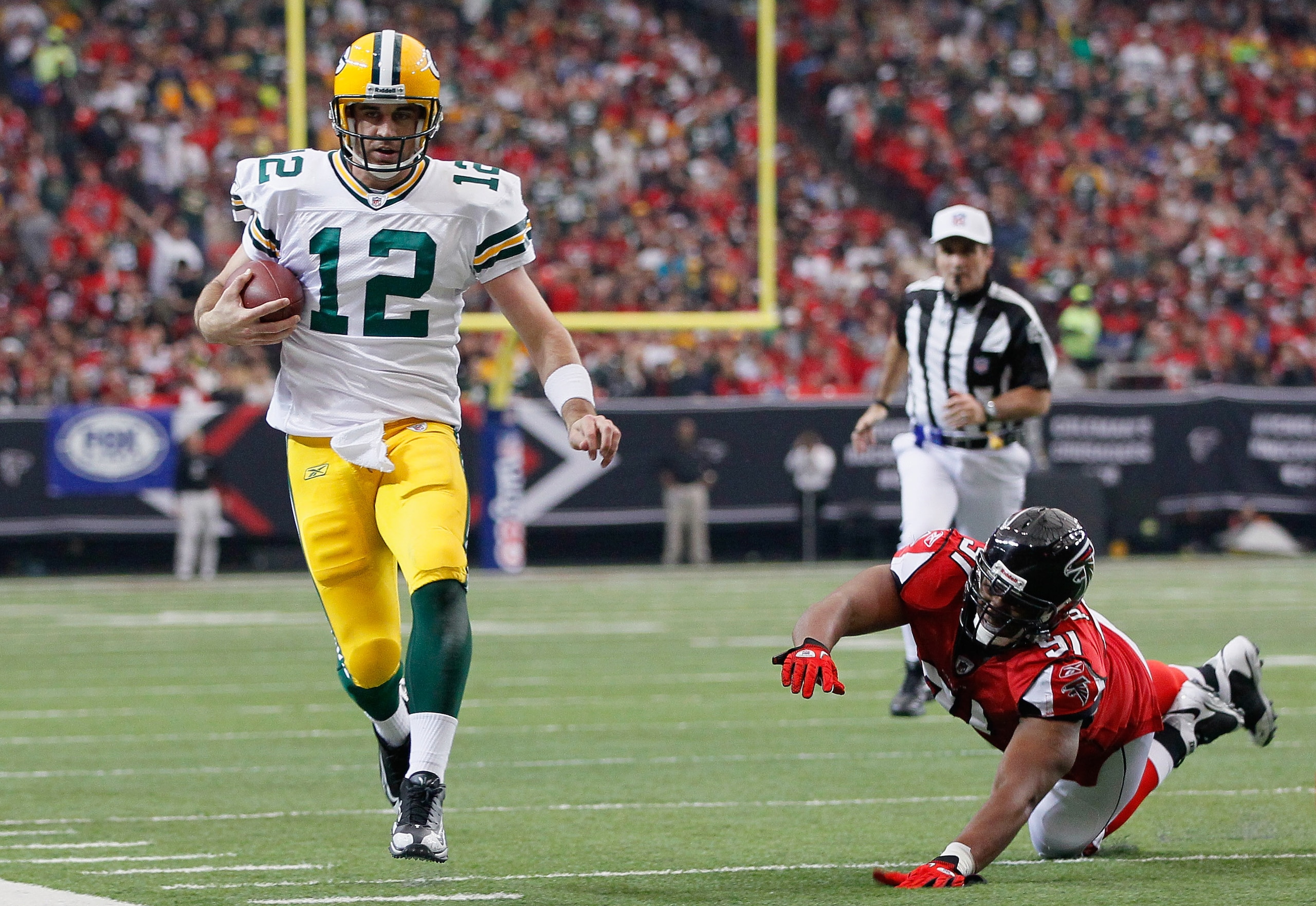 ATLANTA - NOVEMBER 28: Quarterback Aaron Rodgers #12 of the Green Bay Packers rushes upfield away from Corey Peters #91 of the Atlanta Falcons at Georgia Dome on November 28, 2010 in Atlanta, Georgia. (Photo by Kevin C. Cox/Getty Images) ATLANTA - NOVEMBER 28: Quarterback Aaron Rodgers #12 of the Green Bay Packers rushes upfield away from Corey Peters #91 of the Atlanta Falcons at Georgia Dome on November 28, 2010 in Atlanta, Georgia. (Photo by Kevin C. Cox/Getty Images)