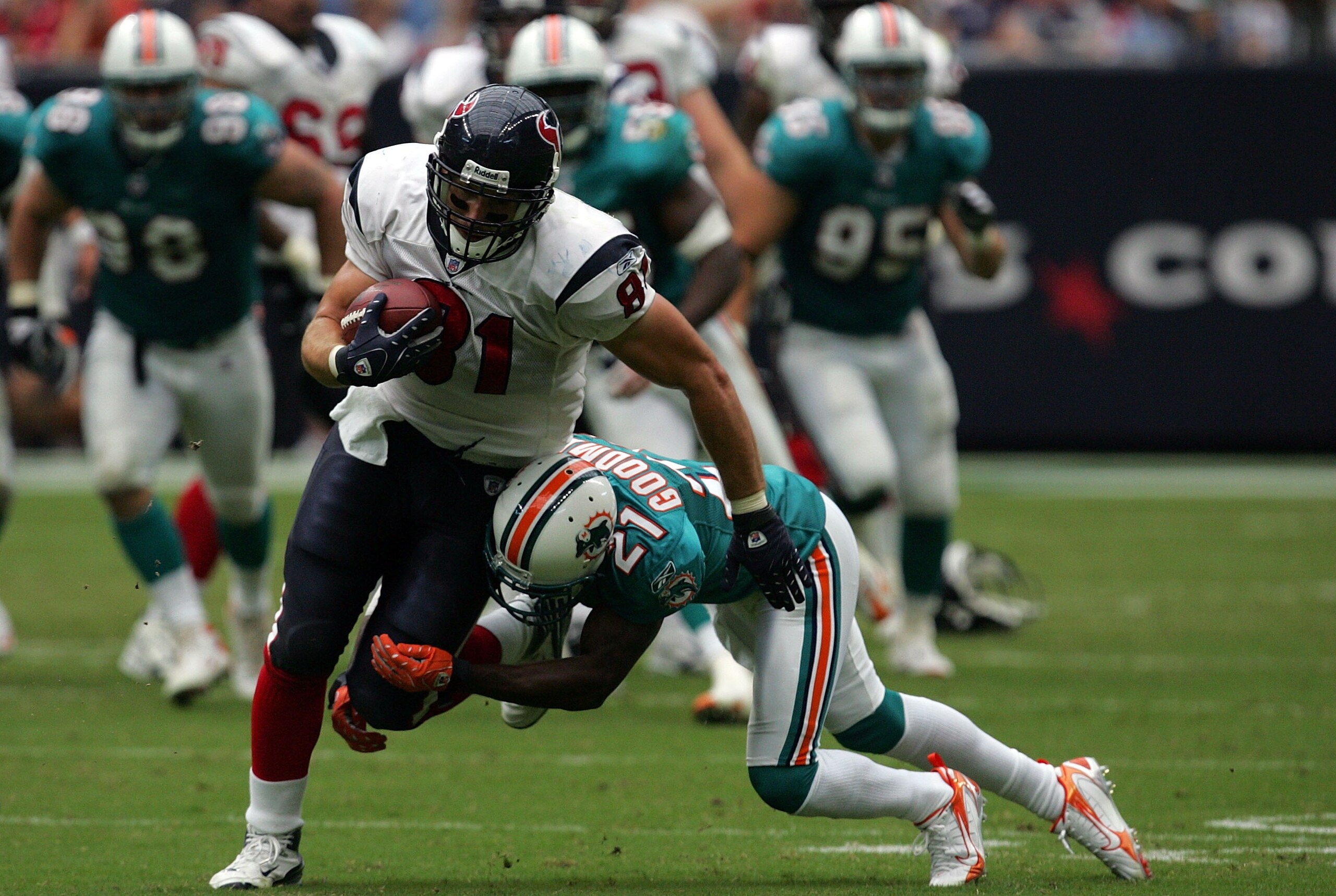 HOUSTON - OCTOBER 07:  Tight end Owen Daniels #81 of the Houston Texans is tackled by Andre Goodman #21 of the Miami Dolphins at Reliant Stadium on October 7, 2007 in Houston, Texas.  (Photo by Ronald Martinez/Getty Images)