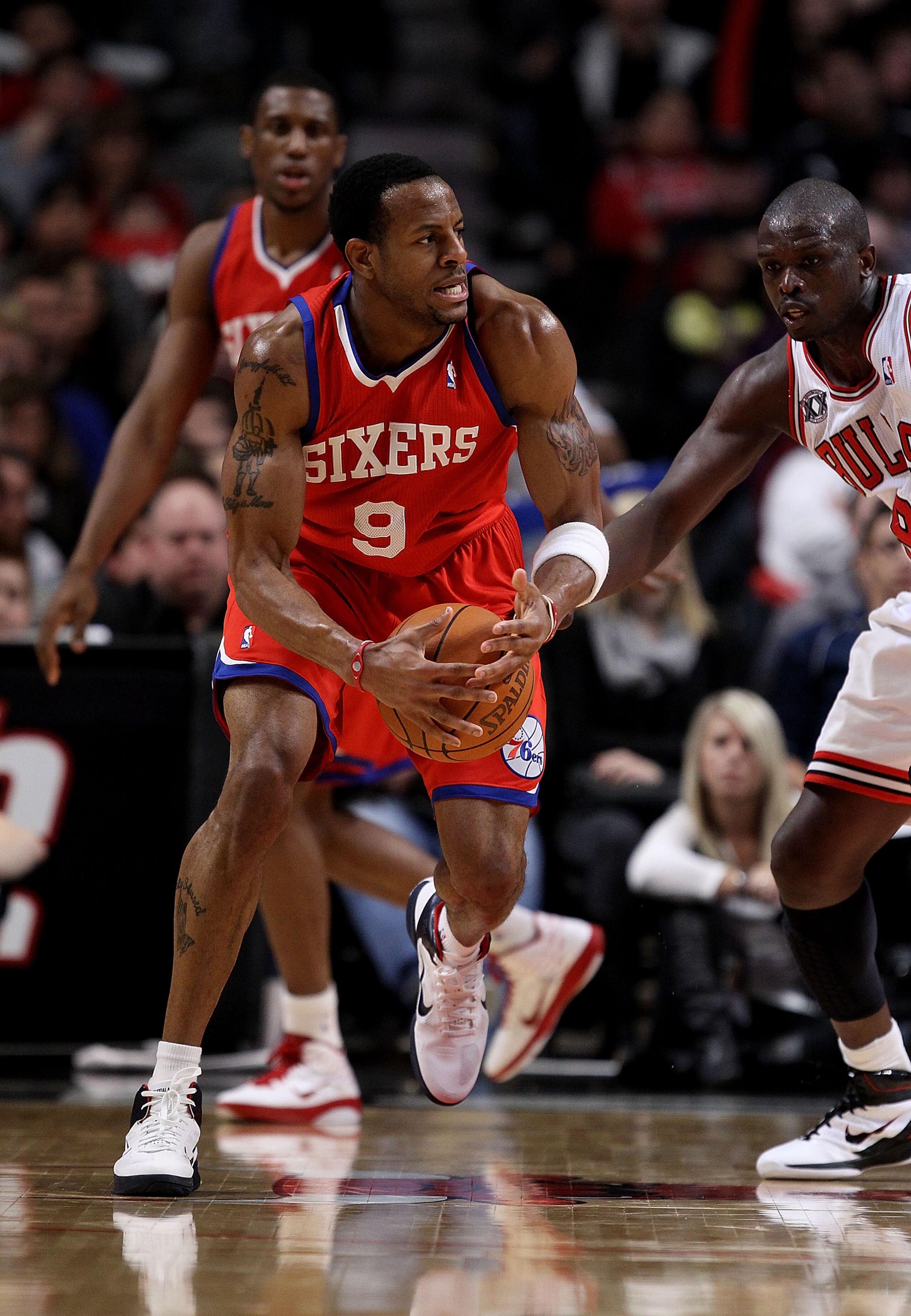 CHICAGO, IL - DECEMBER 21: Andre Iguodala #9 of the Philadelphia 76ers tries to move against Loul Deng #9 of the Chicago Bulls at the United Center on December 21, 2010 in Chicago, Illinois. The Bulls defeated the 76ers 121-76. NOTE TO USER: User expressl CHICAGO, IL - DECEMBER 21: Andre Iguodala #9 of the Philadelphia 76ers tries to move against Loul Deng #9 of the Chicago Bulls at the United Center on December 21, 2010 in Chicago, Illinois. The Bulls defeated the 76ers 121-76. NOTE TO USER: User expressl