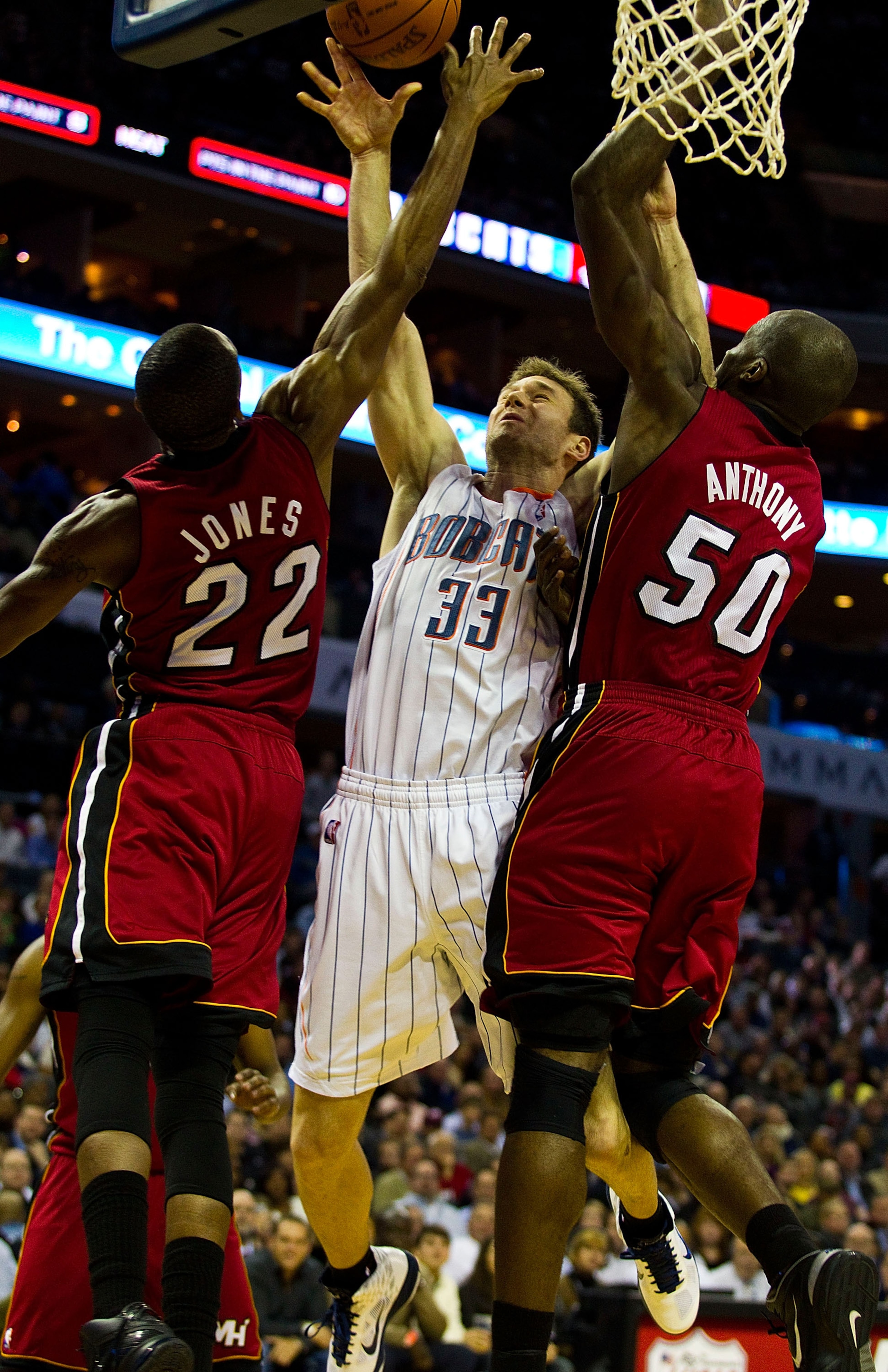CHARLOTTE, NC - JANUARY 03: Matt Carroll #33 of the Charlotte Bobcats tries to shoot over James Jones #22 and Joel Anthony #50 of the Miami Heat at Time Warner Cable Arena on January 3, 2011 in Charlotte, North Carolina. The Heat defeated the Bobcats 96- CHARLOTTE, NC - JANUARY 03: Matt Carroll #33 of the Charlotte Bobcats tries to shoot over James Jones #22 and Joel Anthony #50 of the Miami Heat at Time Warner Cable Arena on January 3, 2011 in Charlotte, North Carolina. The Heat defeated the Bobcats 96-