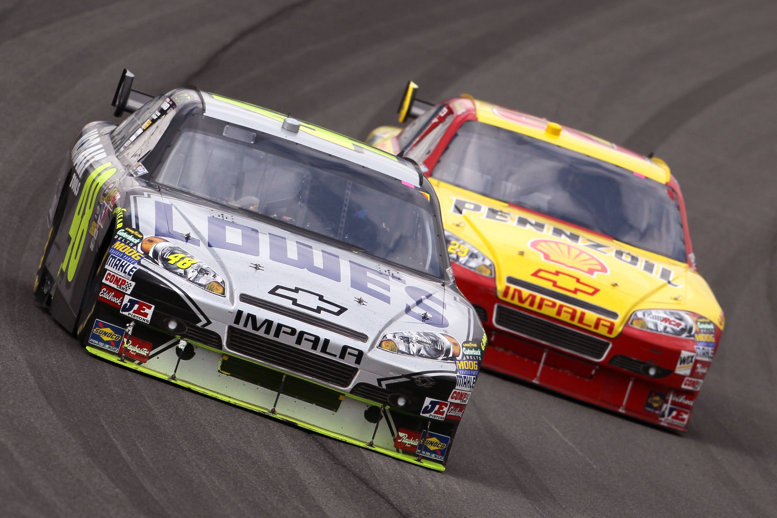 FONTANA, CA - FEBRUARY 21: Jimmie Johnson, driver of the #48 Lowe's/Kobalt Tools Chevrolet takes a turn in front of  Kevin Harvick, driver of the #29 Shell Pennzoil Chevrolet, during the NASCAR Sprint Cup Series Auto Club 500 at Auto Club Speedway on Febr