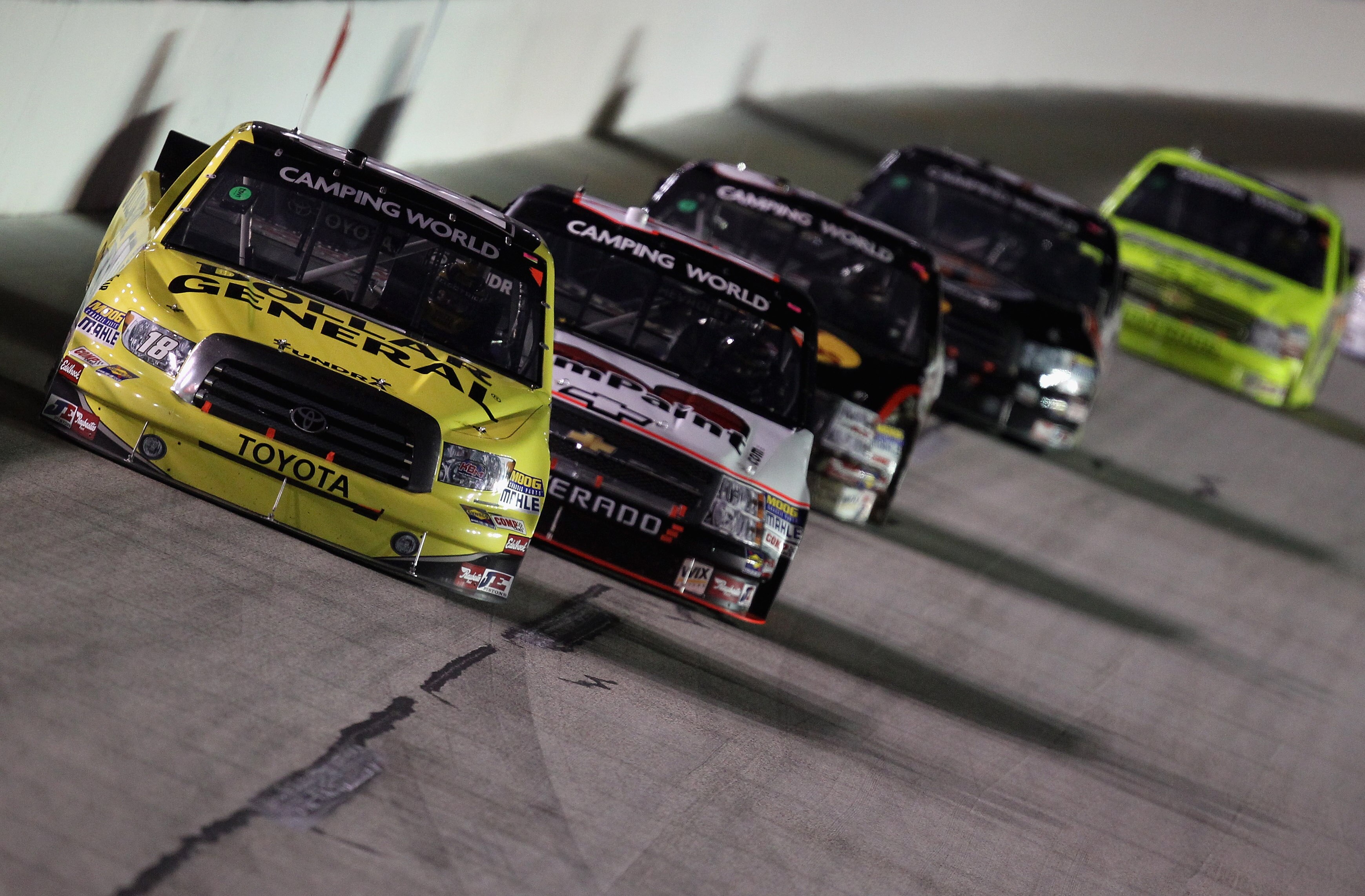 SPARTA, KY - SEPTEMBER 03:  Kyle Busch, driver of the #18 Dollar General/Toyota Tundra, leads a pack of cars during the NASCAR Camping World Truck Series Built Ford Tough 225 at Kentucky Speedway on September 3, 2010 in Sparta, Kentucky.  (Photo by Street