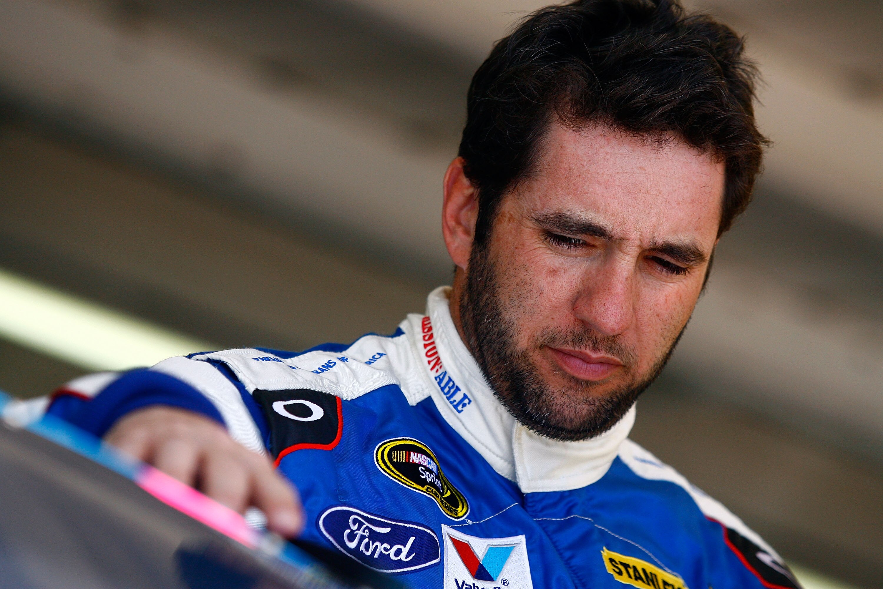 AVONDALE, AZ - NOVEMBER 12:  Elliott Sadler, driver of the #19 Paralyzed Veterans of America Ford, stands in the garage during practice for the NASCAR Sprint Cup Series Kobalt Tools 500 at Phoenix International Raceway on November 12, 2010 in Avondale, Ar