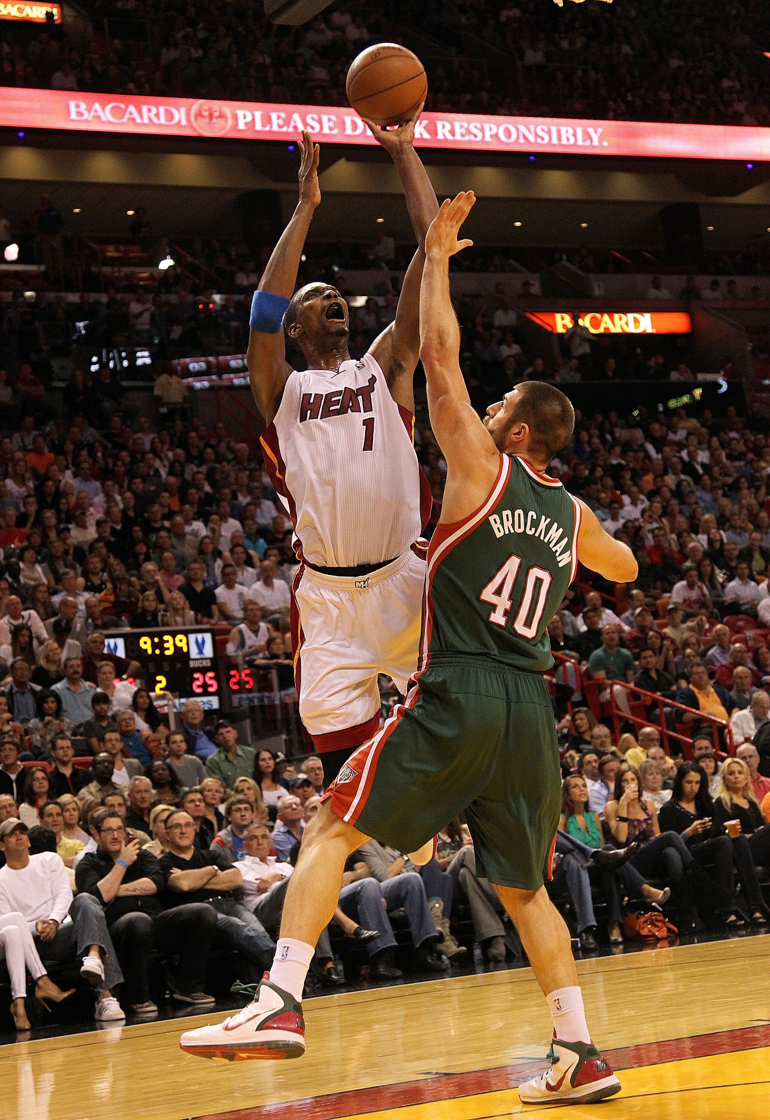 MIAMI, FL - JANUARY 04: Chris Bosh #1 of the Miami Heat shoots over Jon Brockman of the Milwaukee Bucks during a game at American Airlines Arena on January 4, 2011 in Miami, Florida. NOTE TO USER: User expressly acknowledges and agrees that, by downloadin