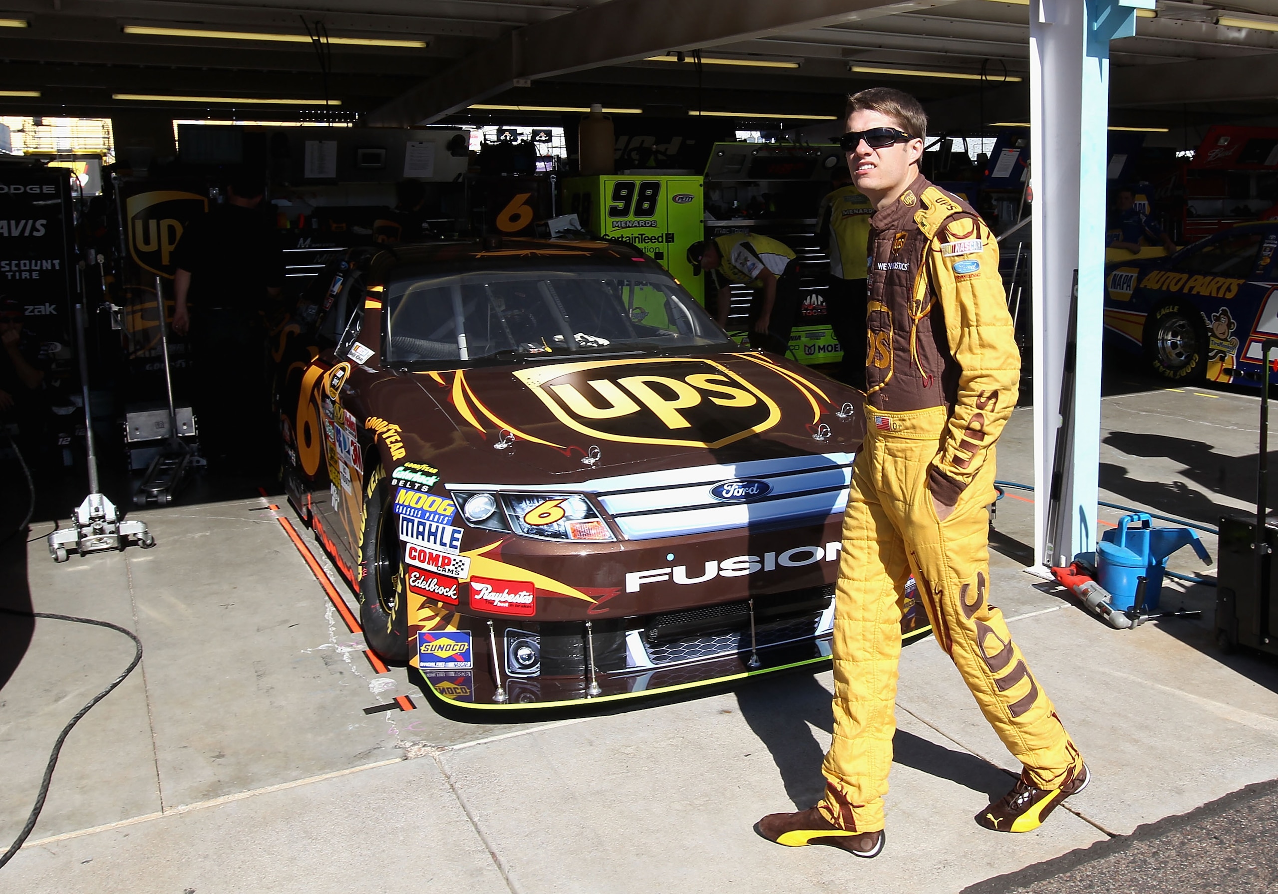 AVONDALE, AZ - NOVEMBER 12:  David Ragan, driver of the #6 UPS Ford, walks in the garage area during practice for the NASCAR Sprint Cup Series Kobalt Tools 500 at Phoenix International Raceway on November 12, 2010 in Avondale, Arizona.  (Photo by Christia