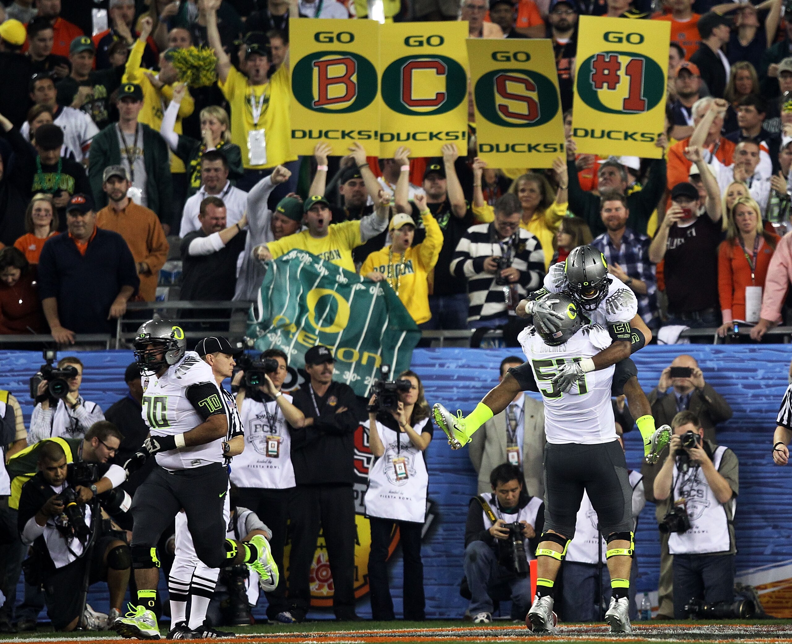 GLENDALE, AZ - JANUARY 10:  LaMichael James #21 and Jordan Holmes #54 of the Oregon Ducks celebrate James' eight-yard touchdown reception in the second quarter against the Auburn Tigers during the Tostitos BCS National Championship Game at University of P