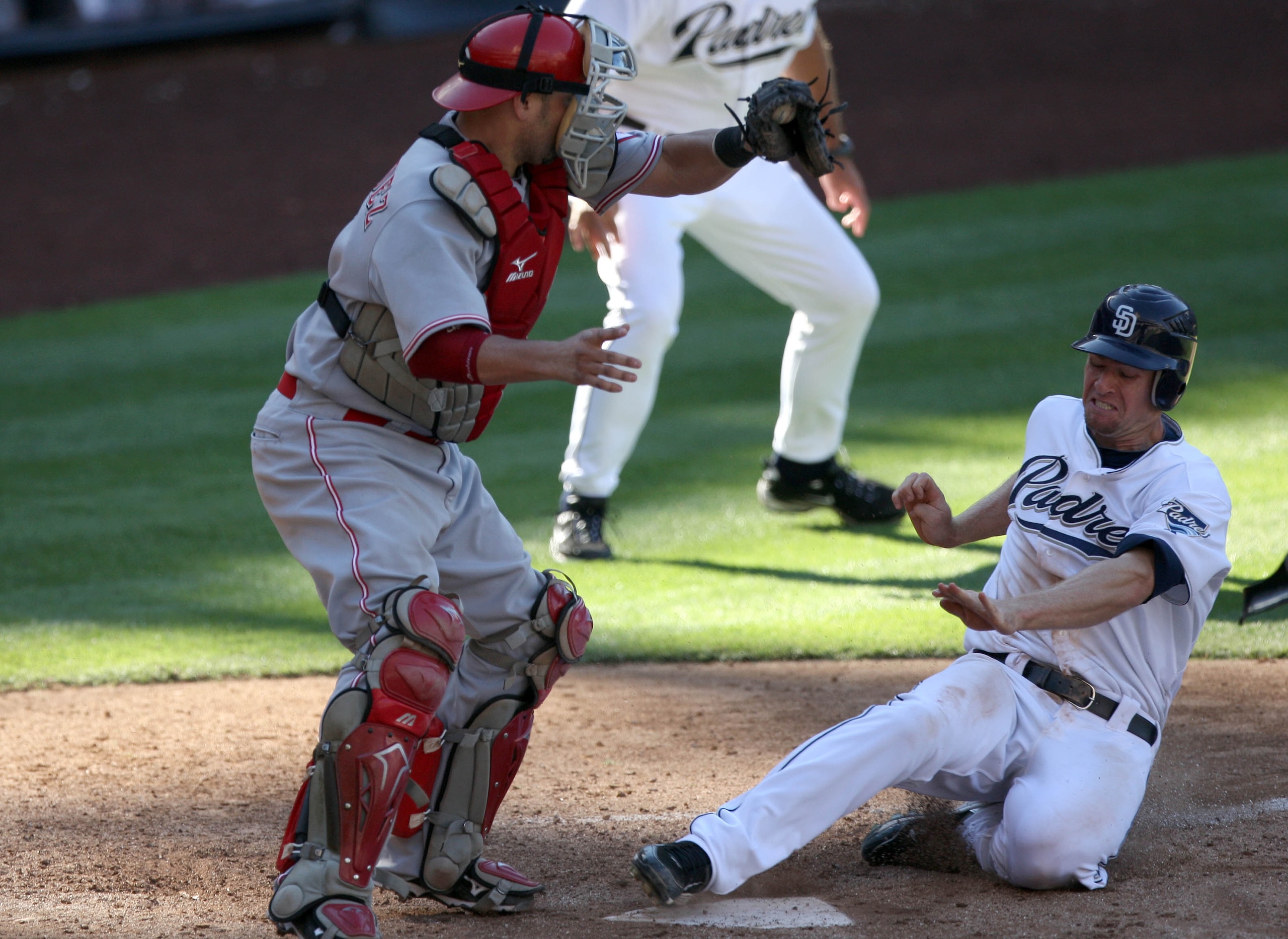 SAN DIEGO, CA - SEPTEMBER 25: Chase Headley #7 of the San Diego Padres slides past the tag of catcher Ramon Hernandez #55 of Cincinnati Reds for the winning score during the Padres 4-3 win in their MLB game on September 25, 2010 at PETCO Park in San Dieg SAN DIEGO, CA - SEPTEMBER 25: Chase Headley #7 of the San Diego Padres slides past the tag of catcher Ramon Hernandez #55 of Cincinnati Reds for the winning score during the Padres 4-3 win in their MLB game on September 25, 2010 at PETCO Park in San Dieg